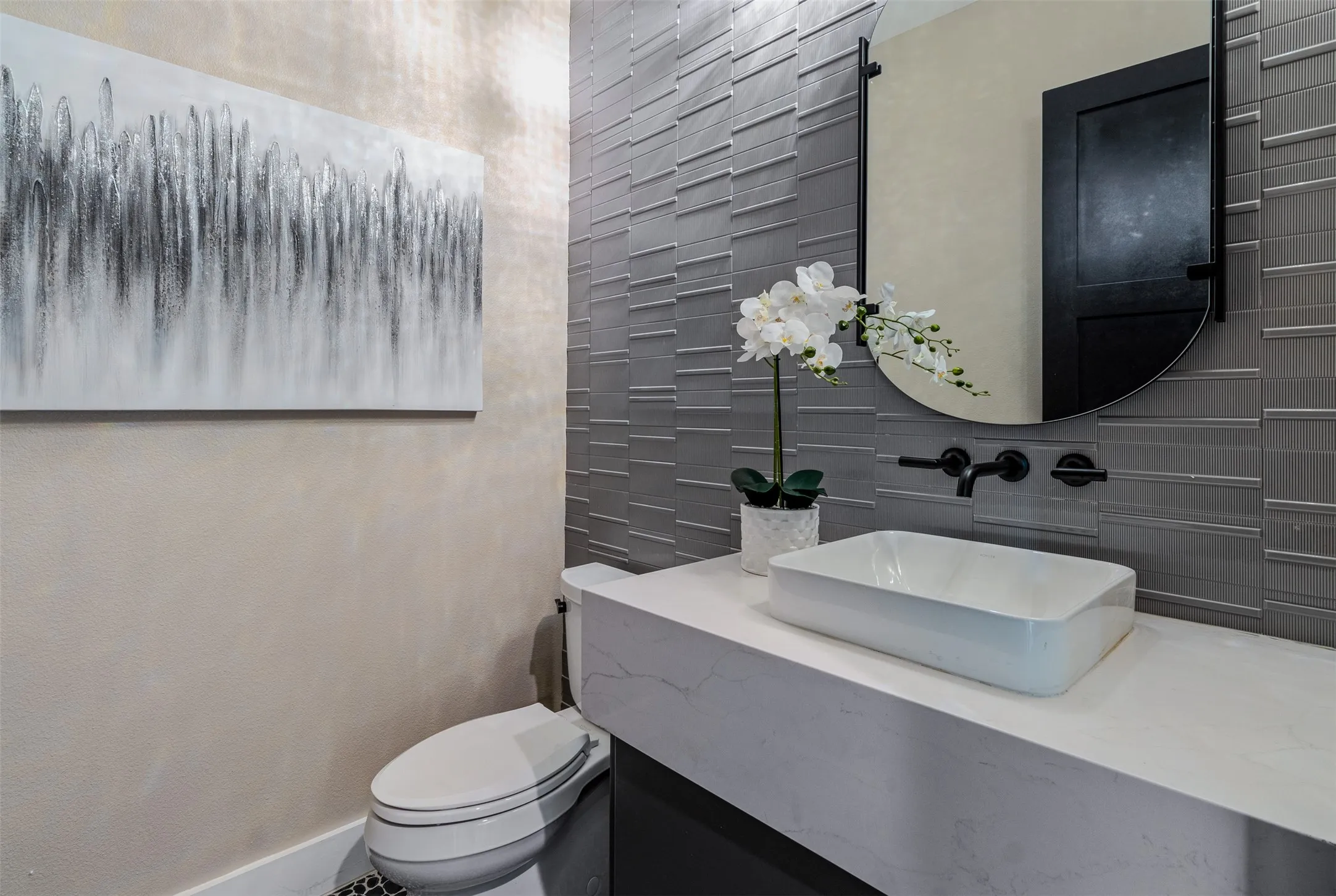 Contemporary bathroom vanity featuring a rectangular vessel sink, white countertop, and matte black wall-mounted faucet