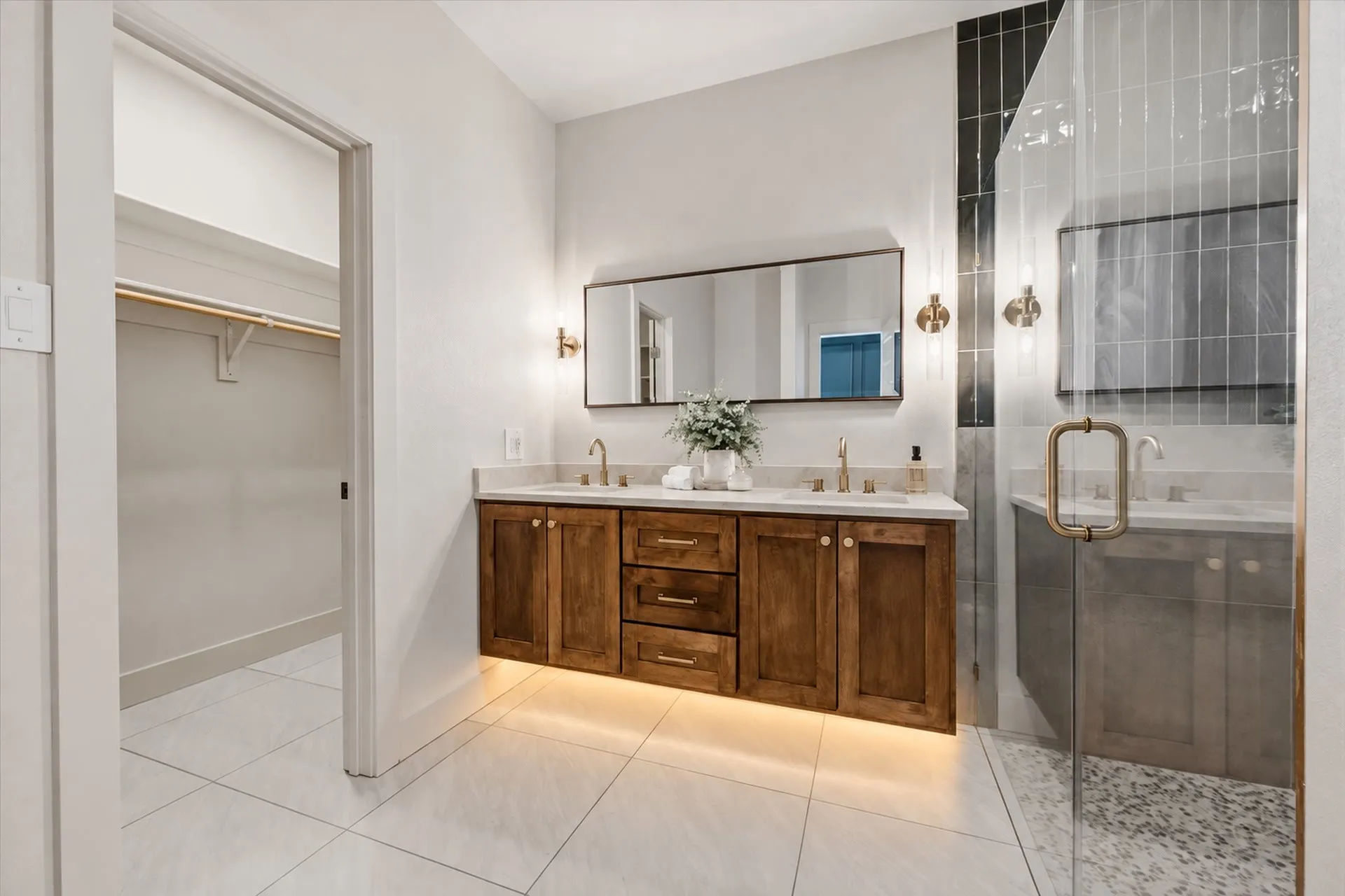 Dual vanity sink with floating cabinets and under-vanity lighting