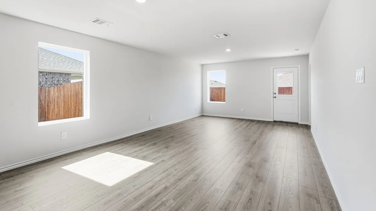 Spacious room featuring wood-finish flooring, recessed lighting, and a neutral color palette