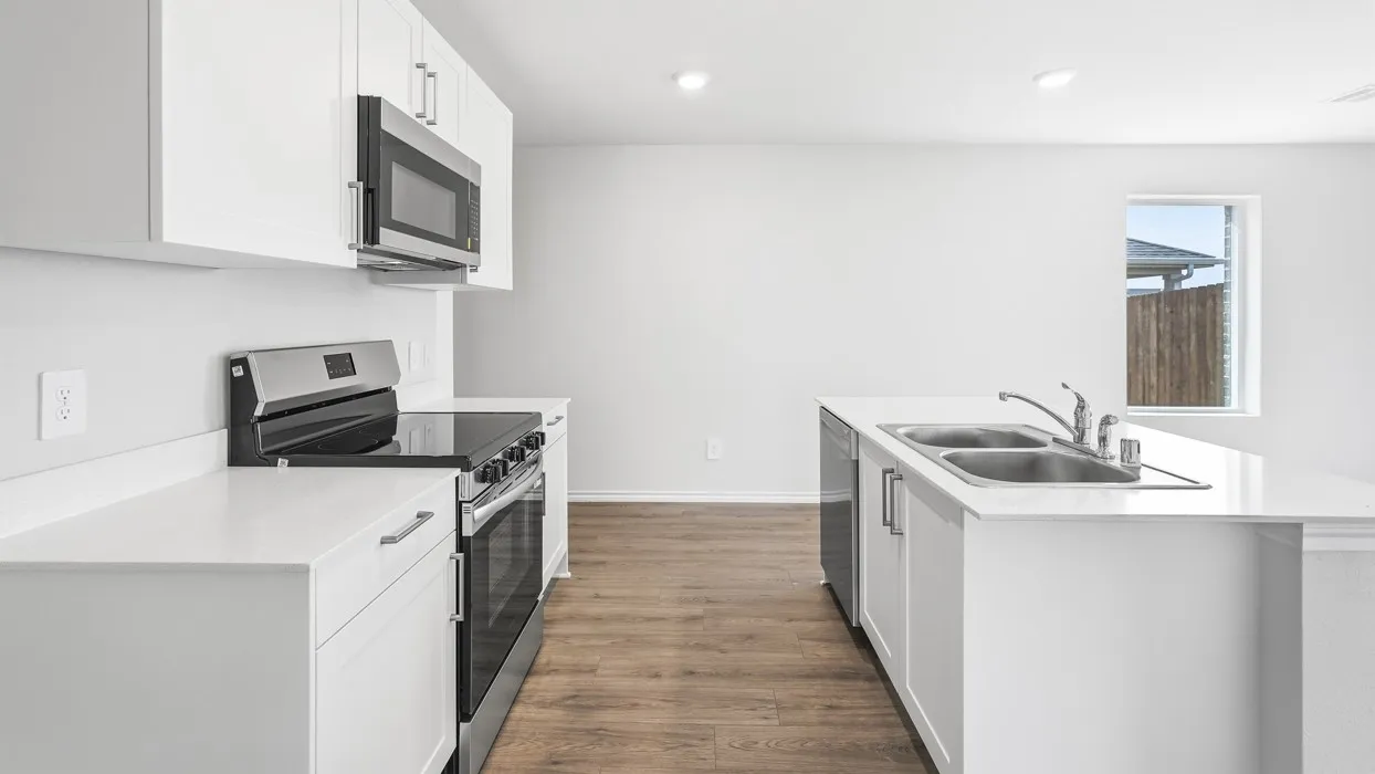 Contemporary kitchen featuring bright white cabinetry, stainless steel appliances, white countertops, a double basin sink, and wood-finish flooring