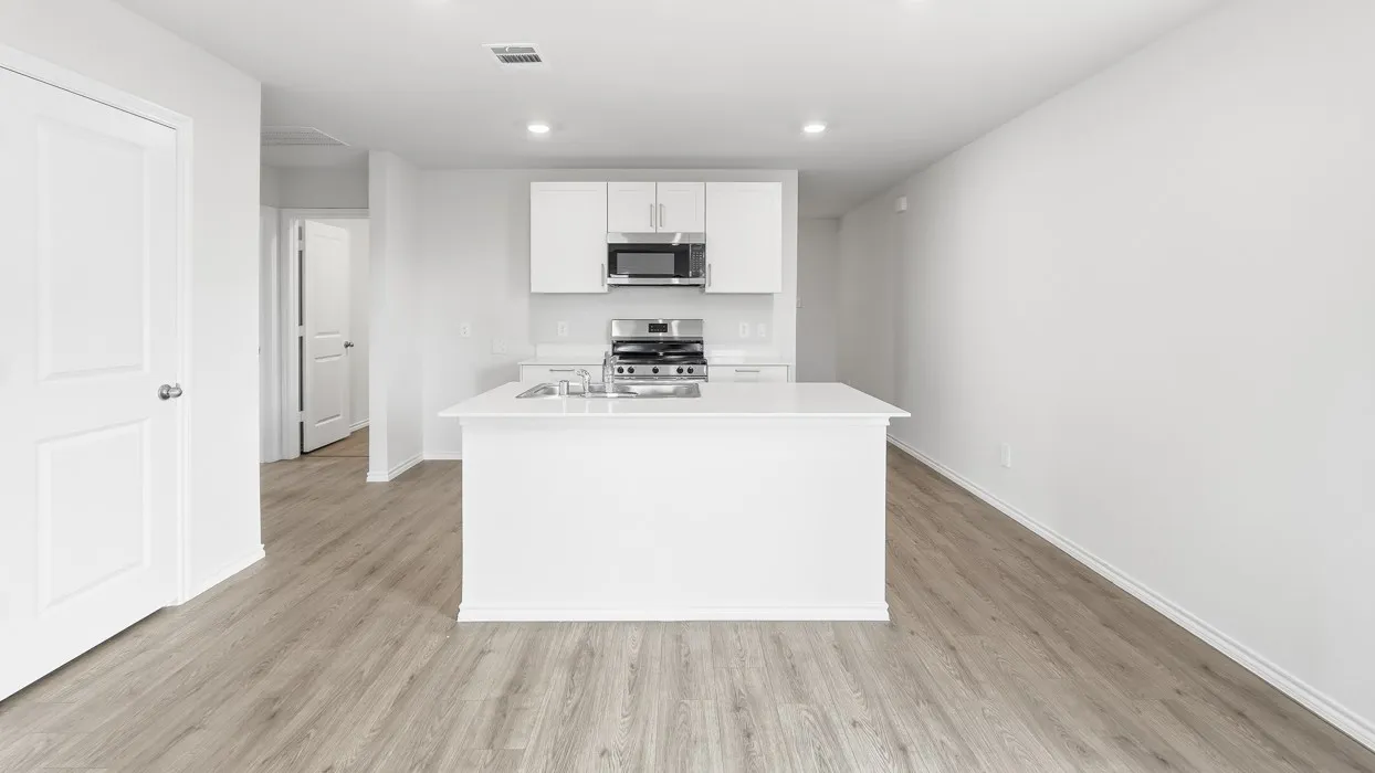 Contemporary kitchen island with a white countertop and integrated sink