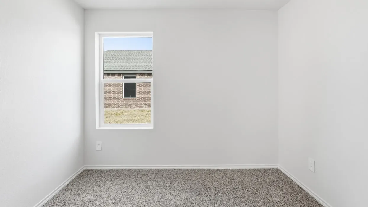 Room featuring a single-pane window, light gray walls, white baseboards, and a gray carpet