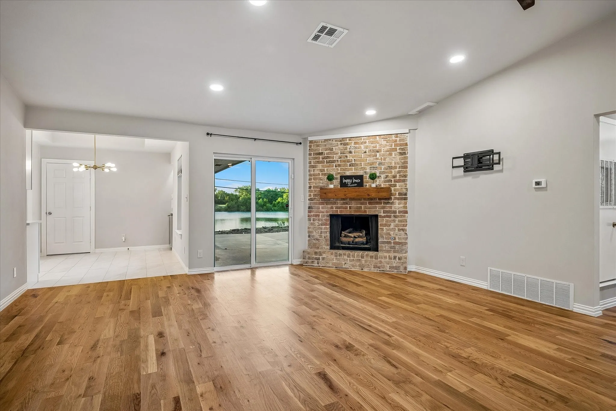 Open to the Breakfast Area and with sliding doors going out to the driveway & patio area with great views of the lake!