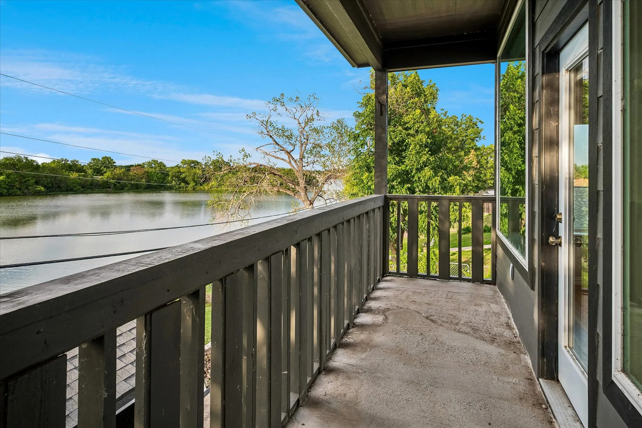 Balcony off of the Second Primary Bedroom overlooks the lake.