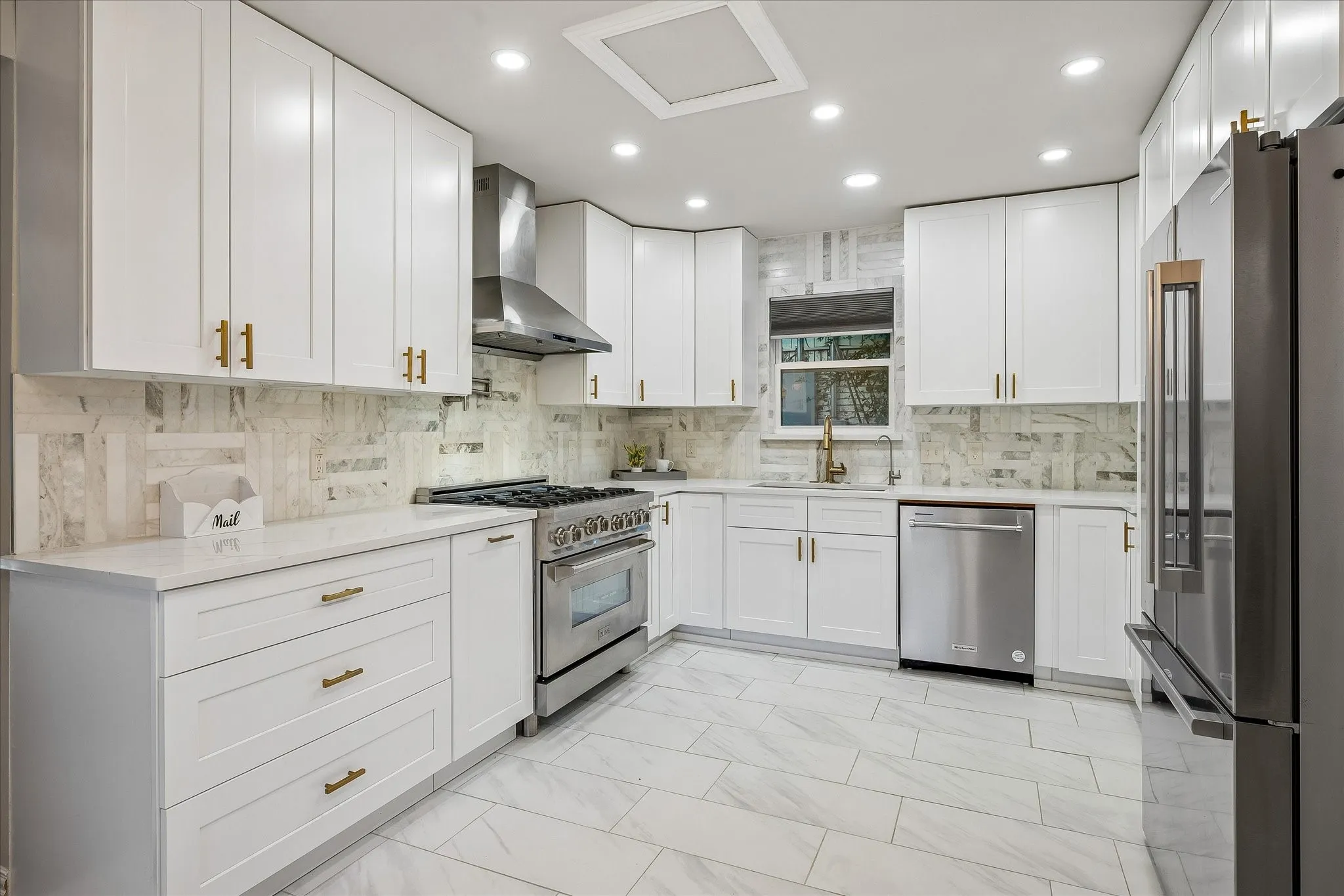 The completely renovated kitchen offers an upscale ZLine Gas Range, Pot Filler, and abundance of cabinets for storage!