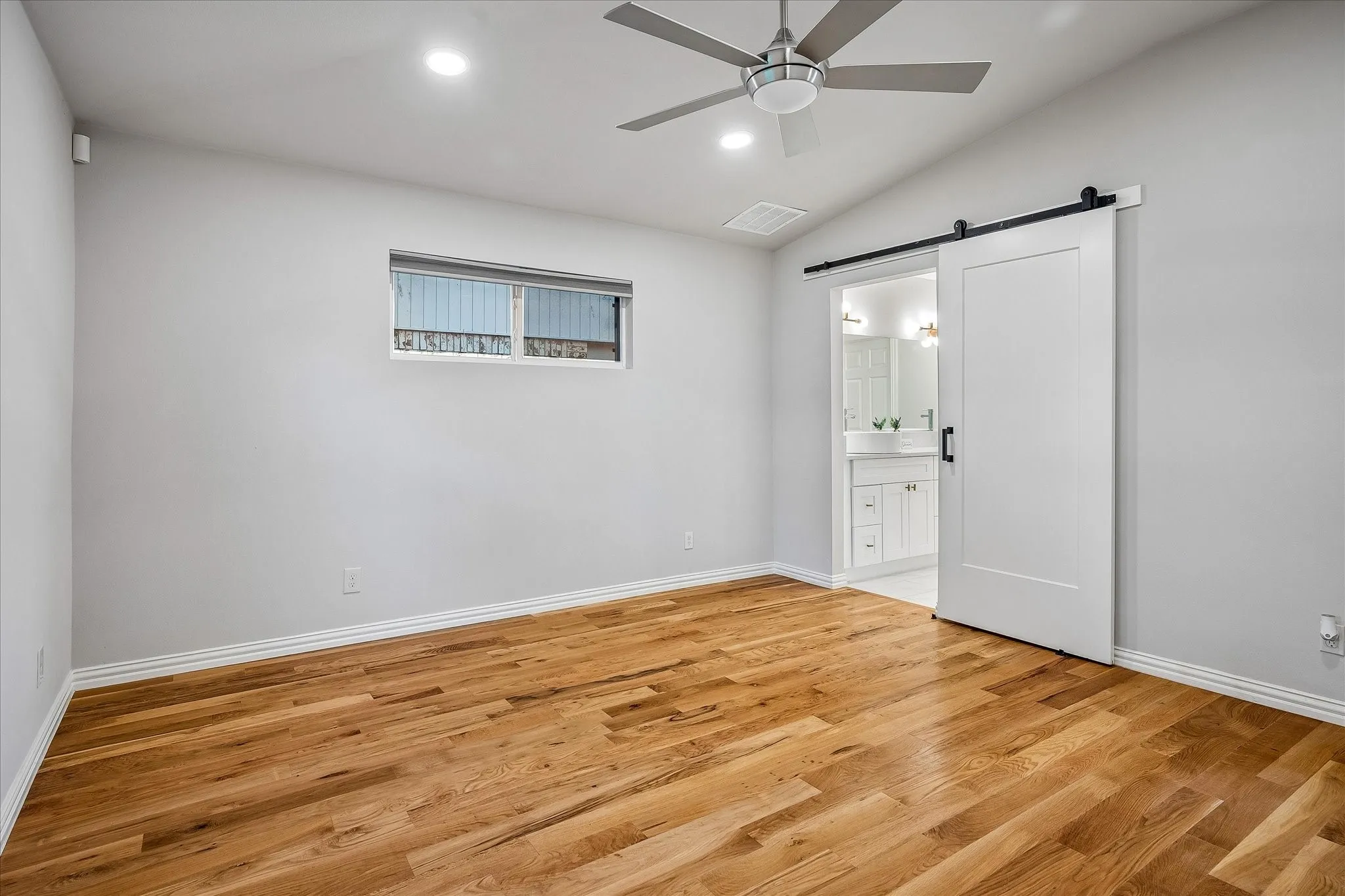 The Primary Bedroom on the 1st Level has an Ensuite with barn-like doors
