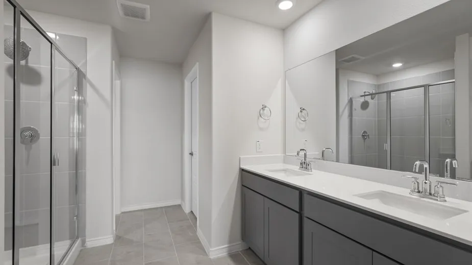 Dual vanity with undermount sinks, chrome fixtures, and a white countertop