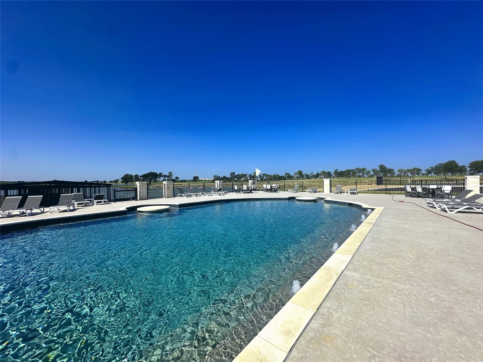 Relax beside the resort-style swimming pool with panoramic lake views