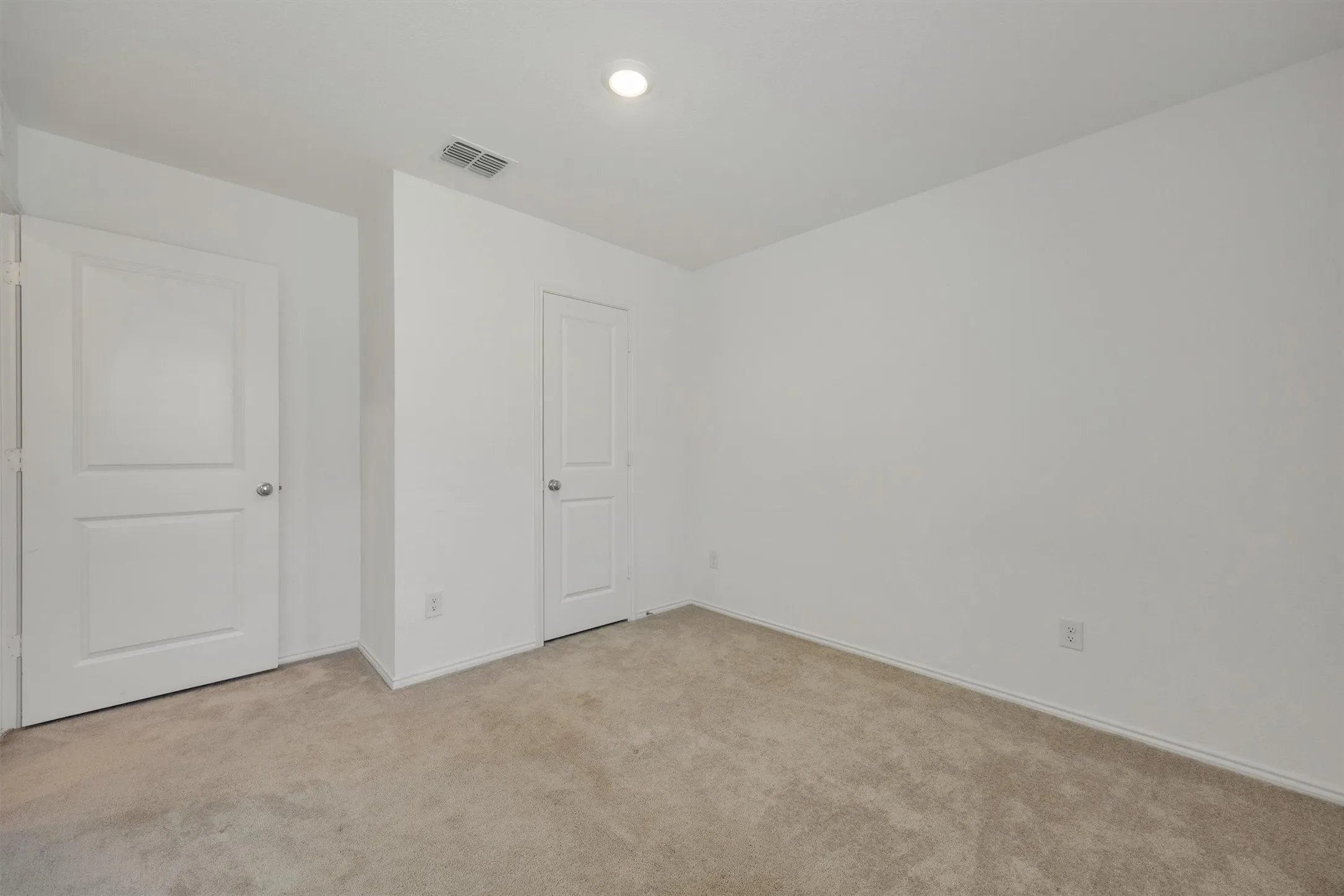 Room featuring neutral carpet flooring, white walls, and a flush-mount ceiling light