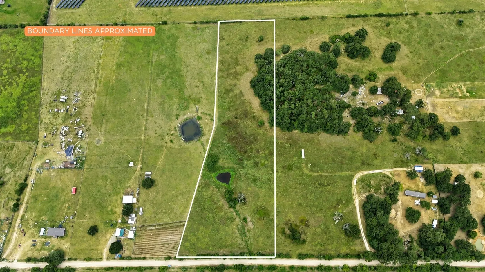 The property’s open layout creates multiple possibilities for a home, shop, barn, or outdoor entertaining space.