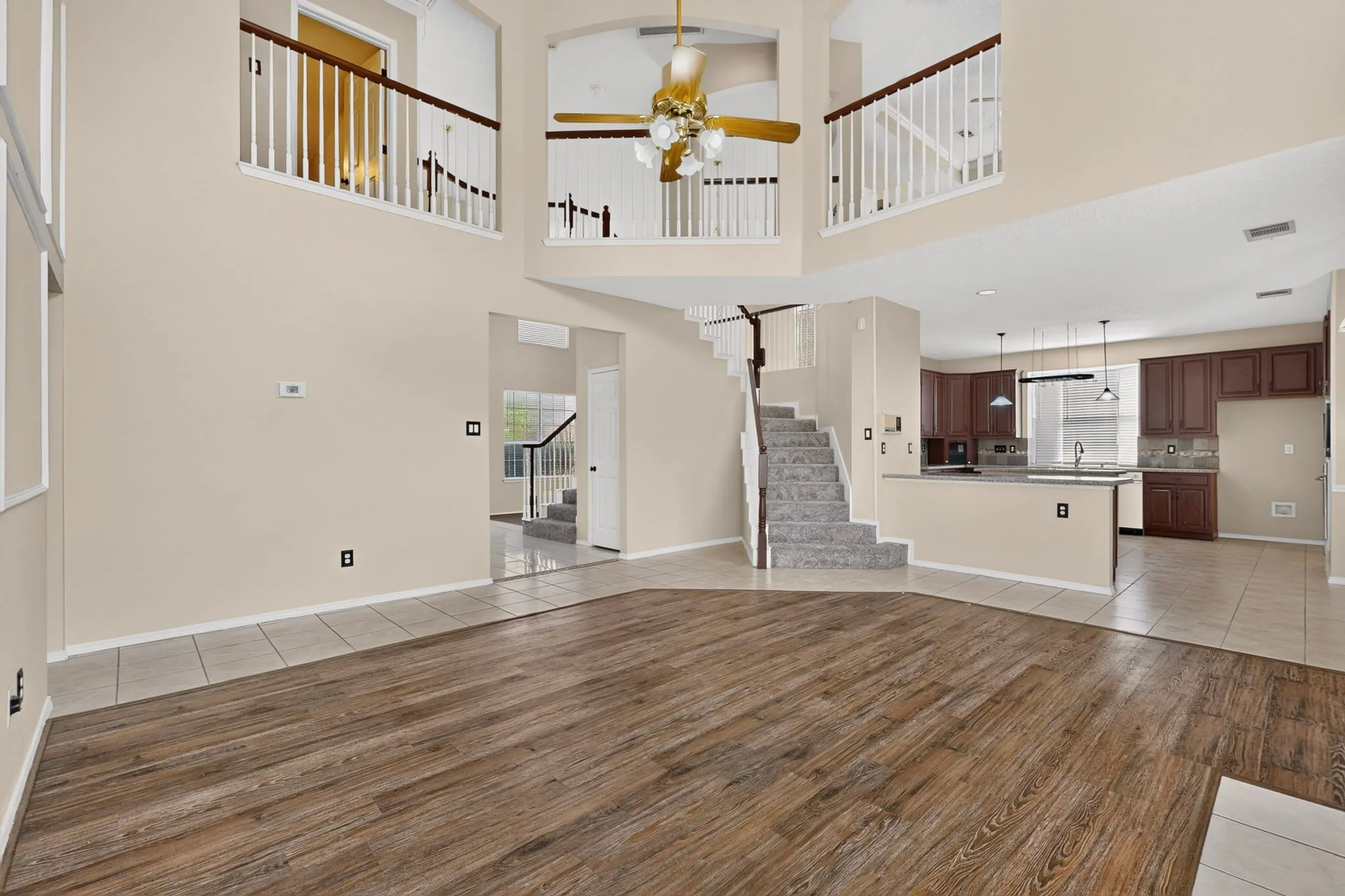 High ceilings featuring a decorative chandelier and multiple overlooks