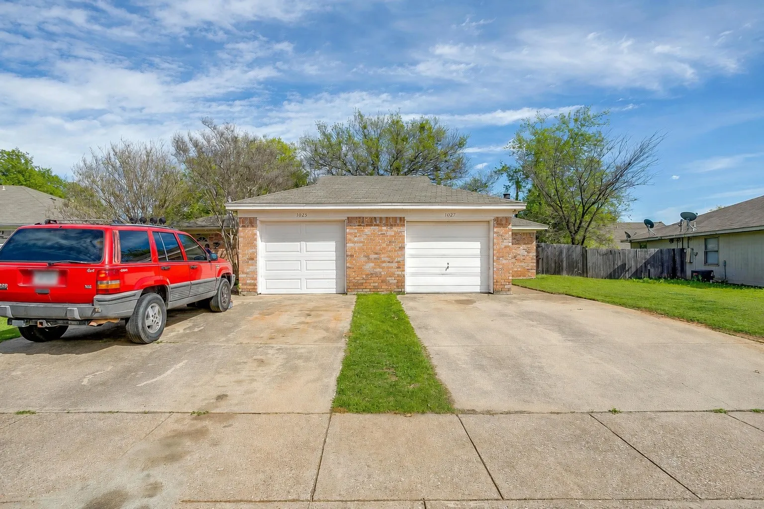 Single family home duplex featuring roof covered with composite shingles and driveways with parking for multiple cars.