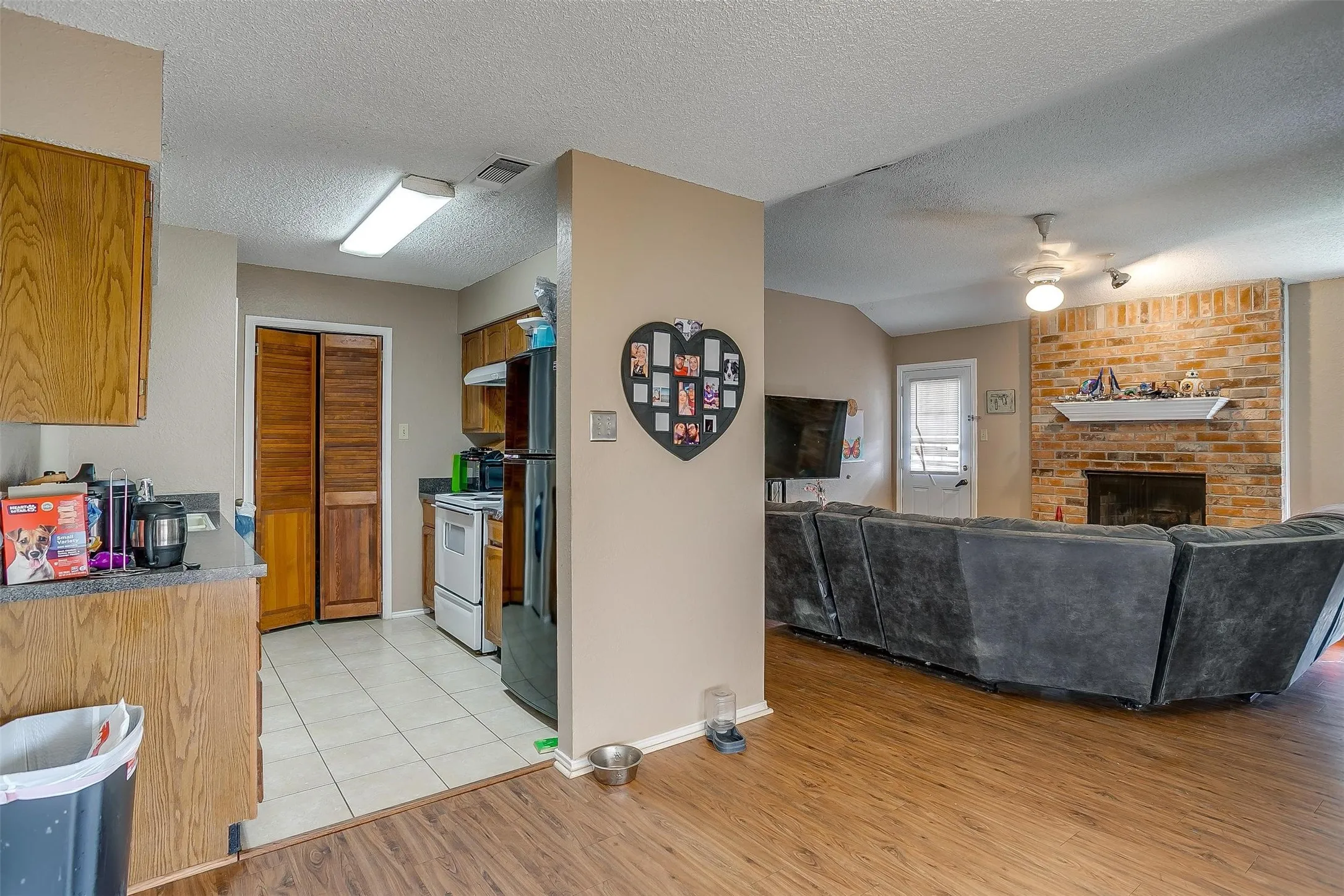 Dining area featuring open floorplan with medium-toned wood-style flooring seamlessly flowing into living room.