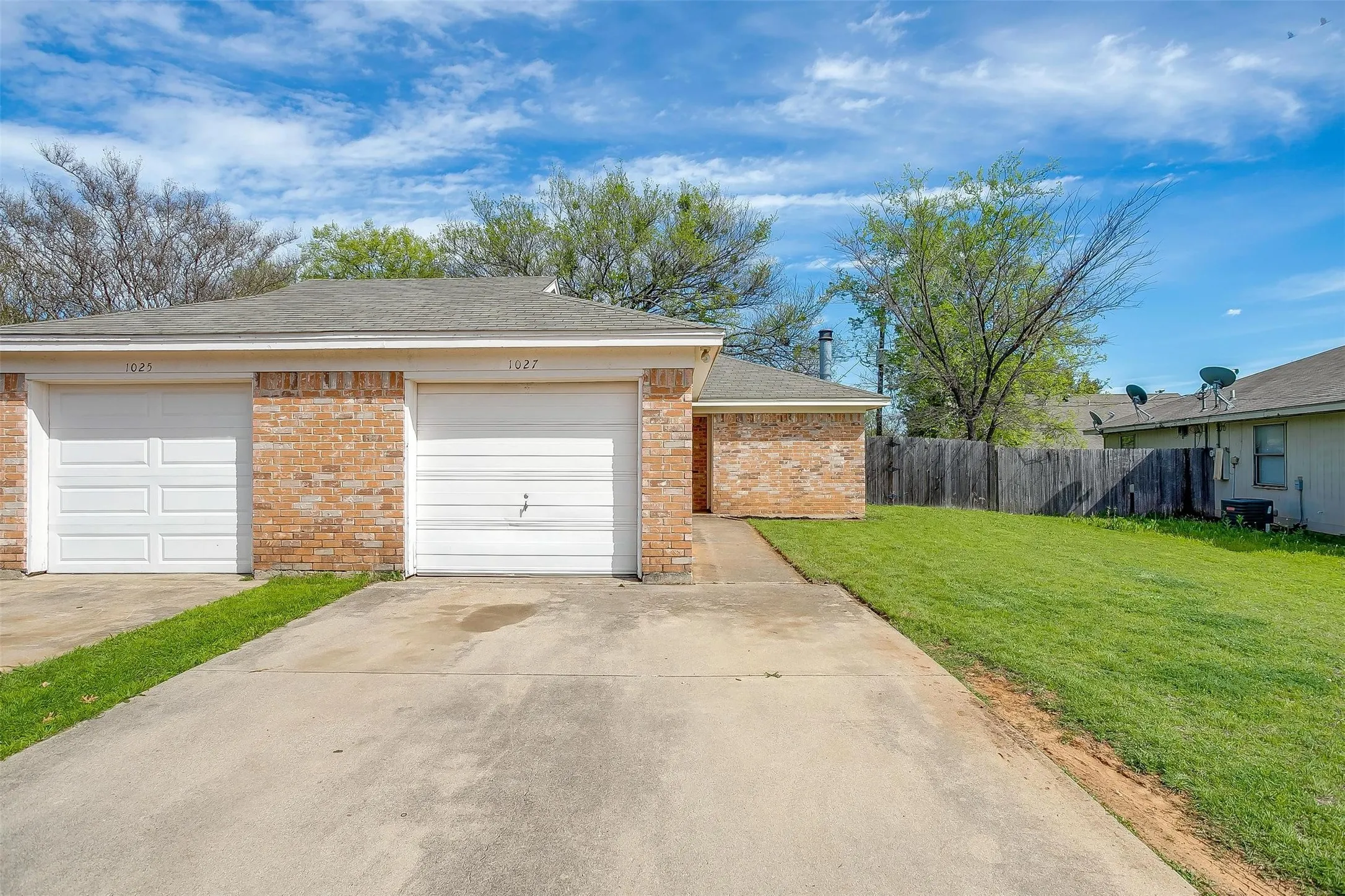 Single family home duplex featuring garage with garage door.