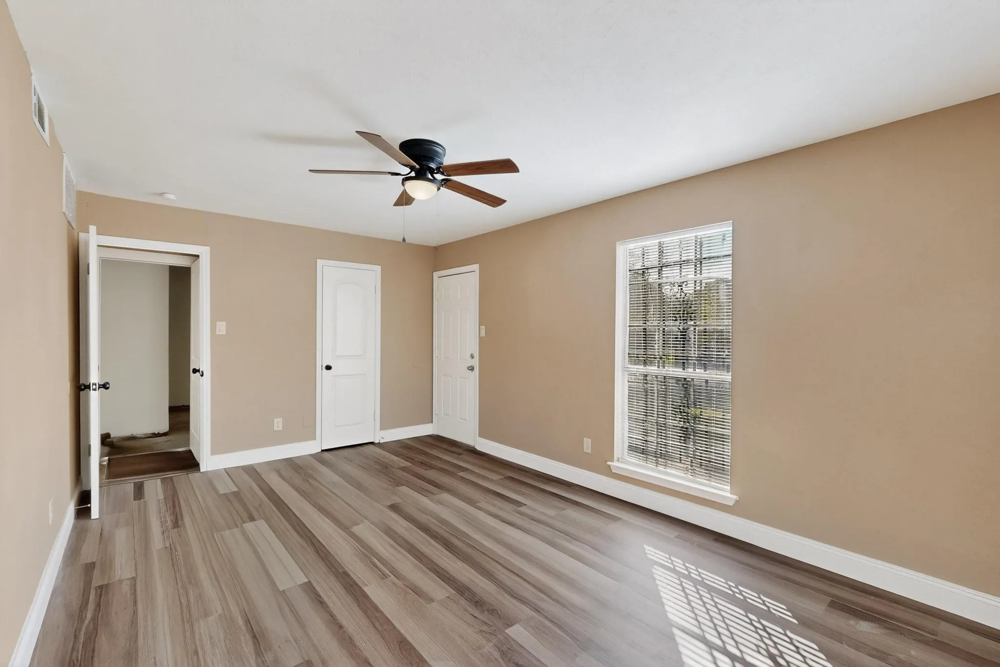 Unfurnished bedroom with light wood-style flooring and ceiling fan