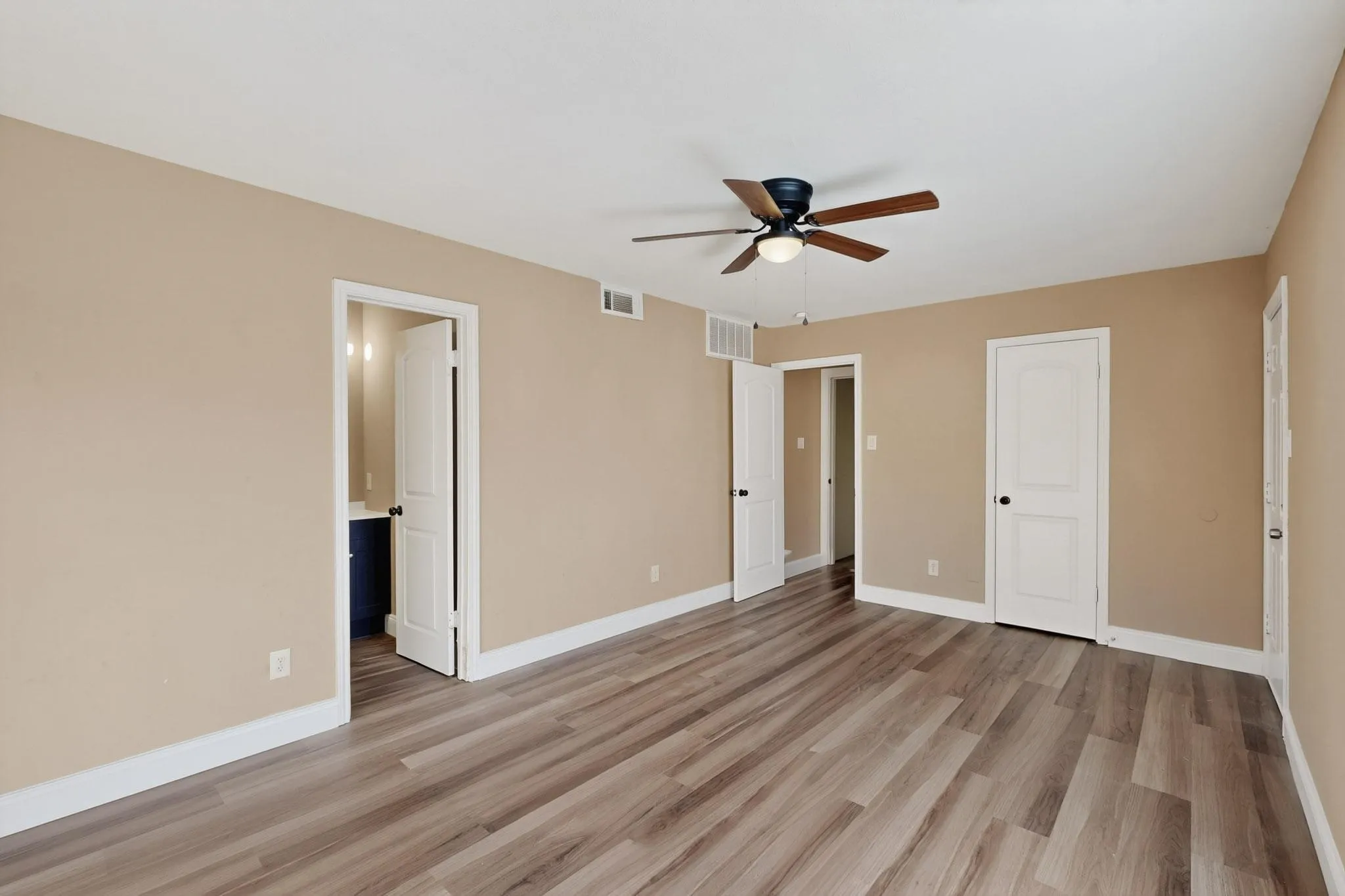 Unfurnished bedroom with light wood-style floors and a ceiling fan
