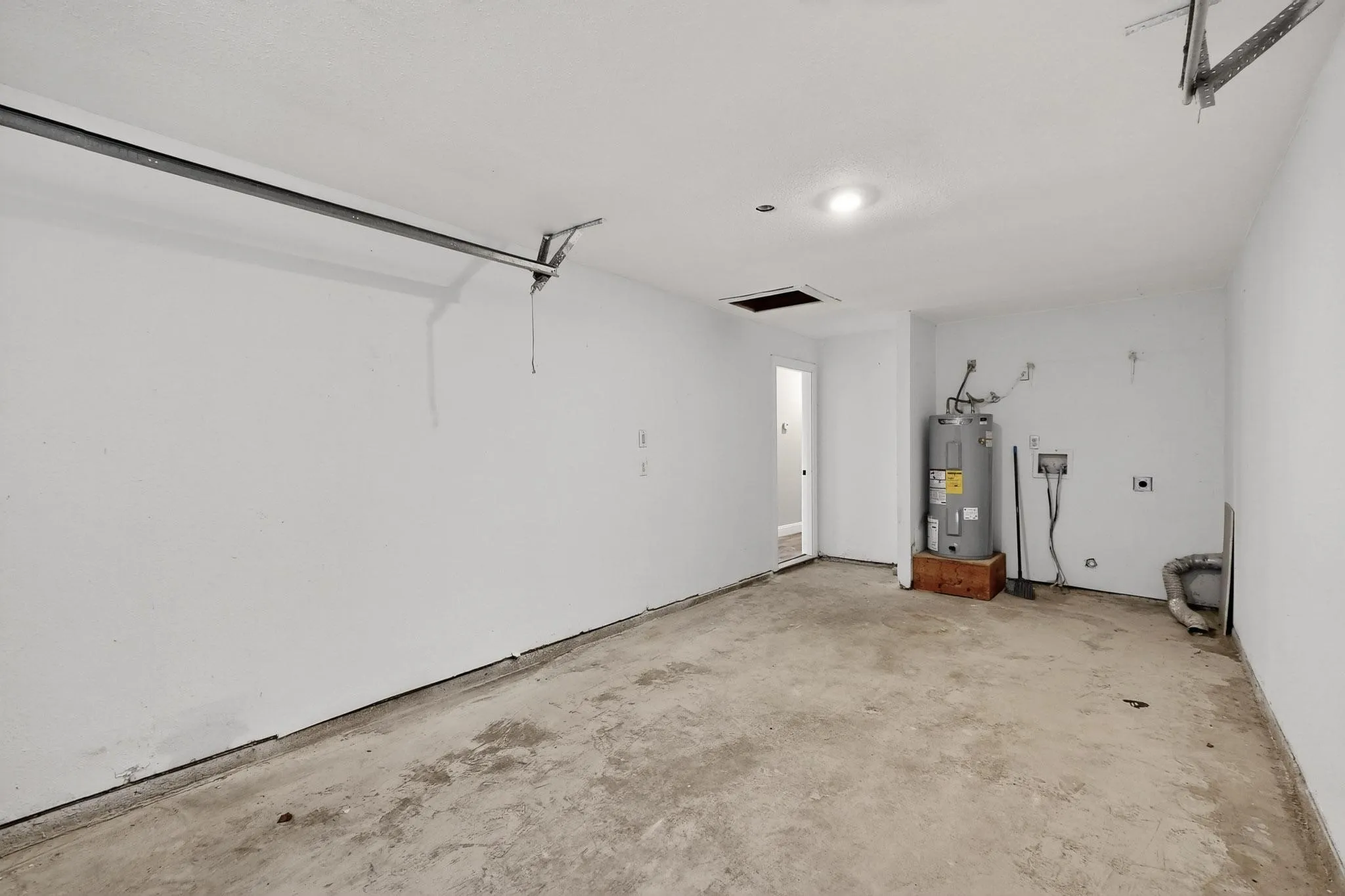 Garage featuring electric water heater