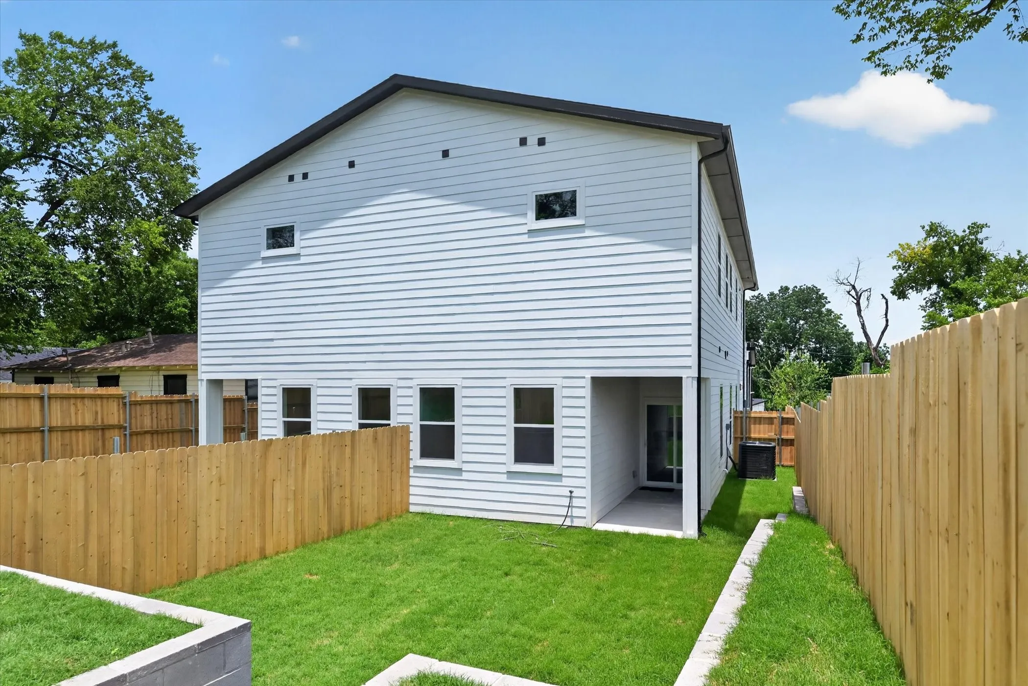 White horizontal siding exterior with a dark trim roofline
