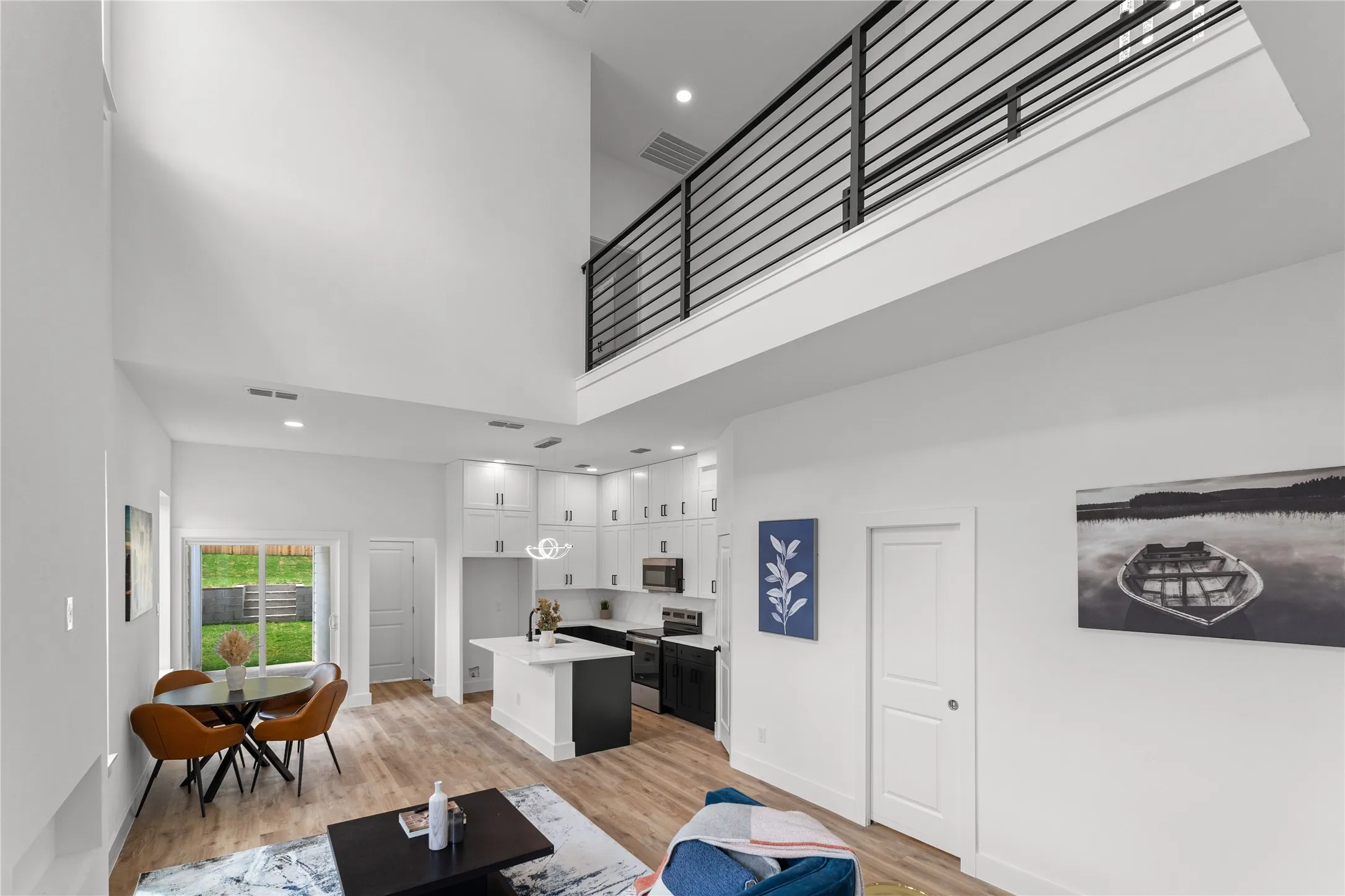 Open-concept living space with high ceilings and wood-finish flooring