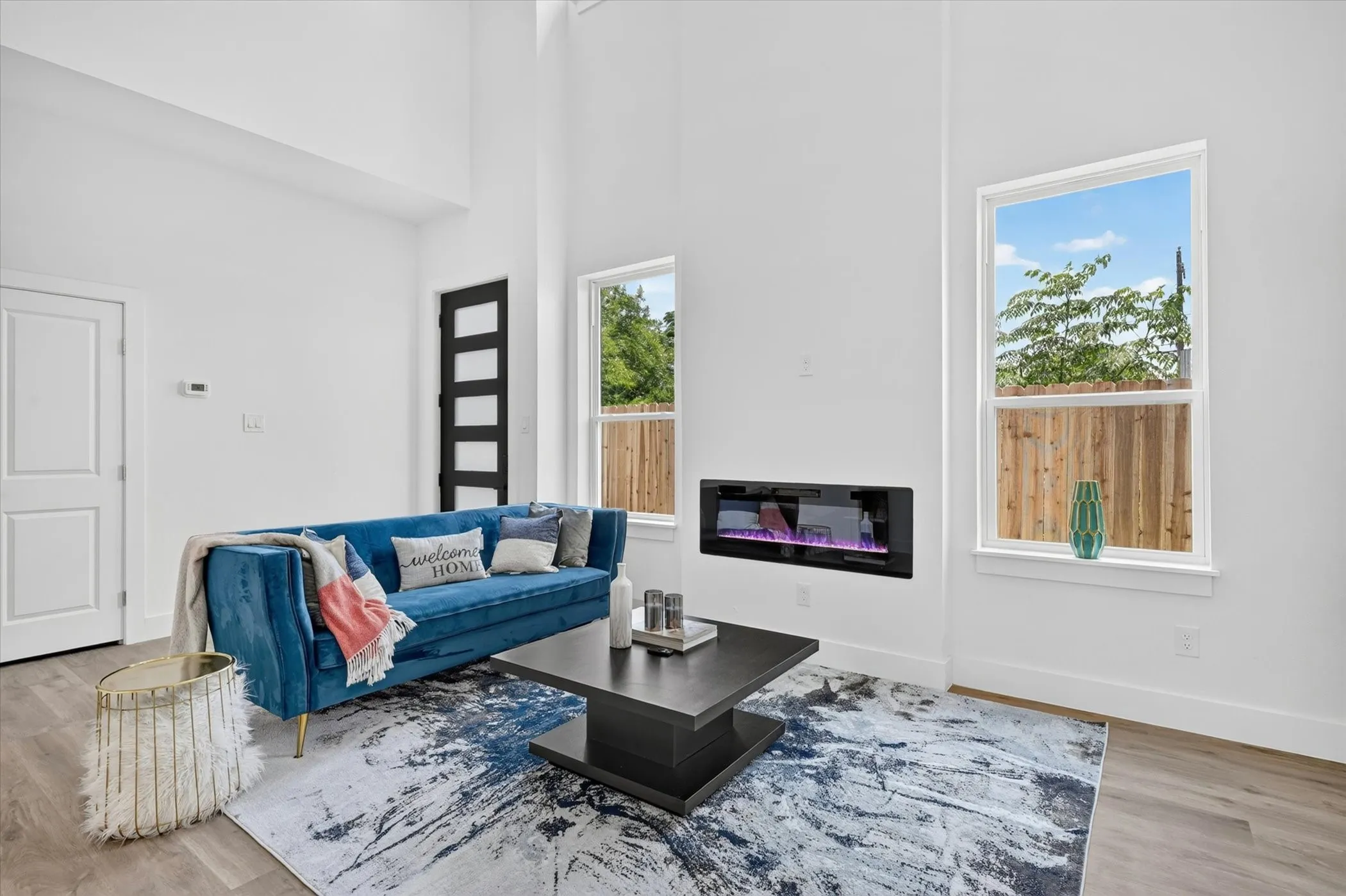Living space featuring wood-finish flooring and a built-in electric fireplace