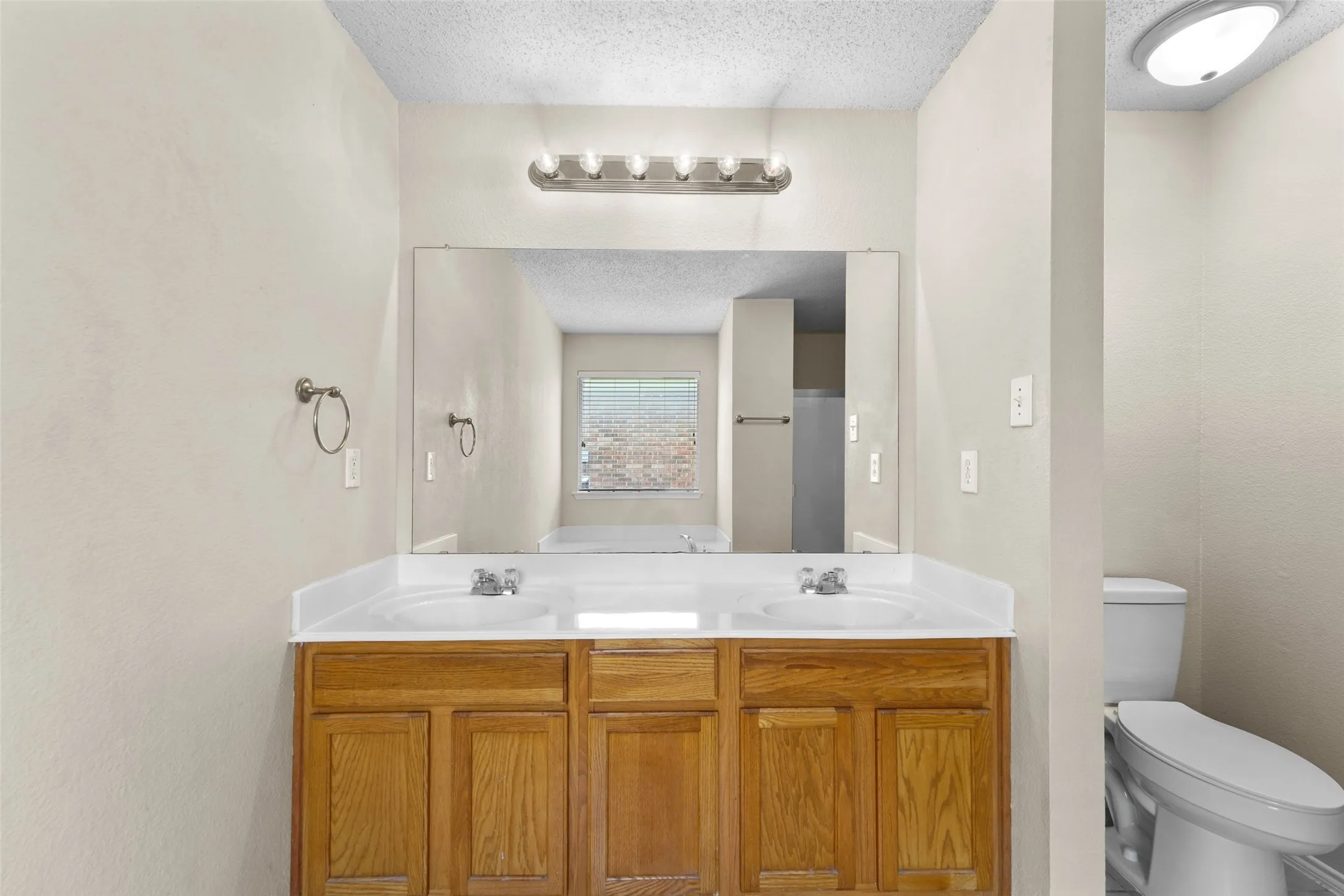 Dual vanity with integrated white sinks and chrome faucets