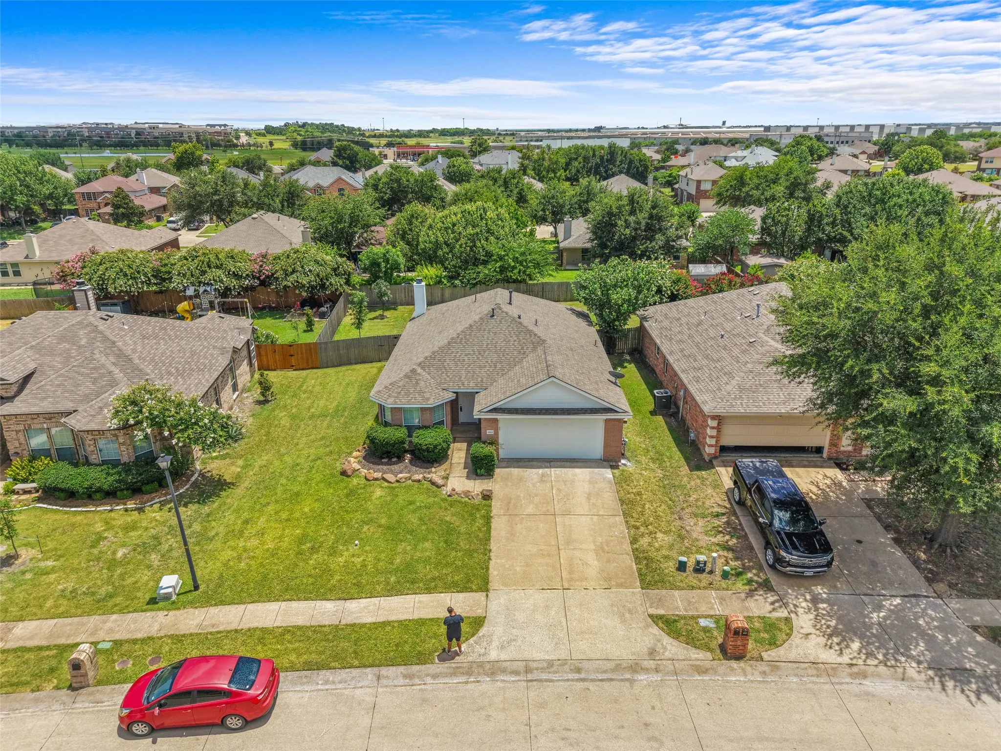 Single-story brick residence with an attached garage and a concrete driveway