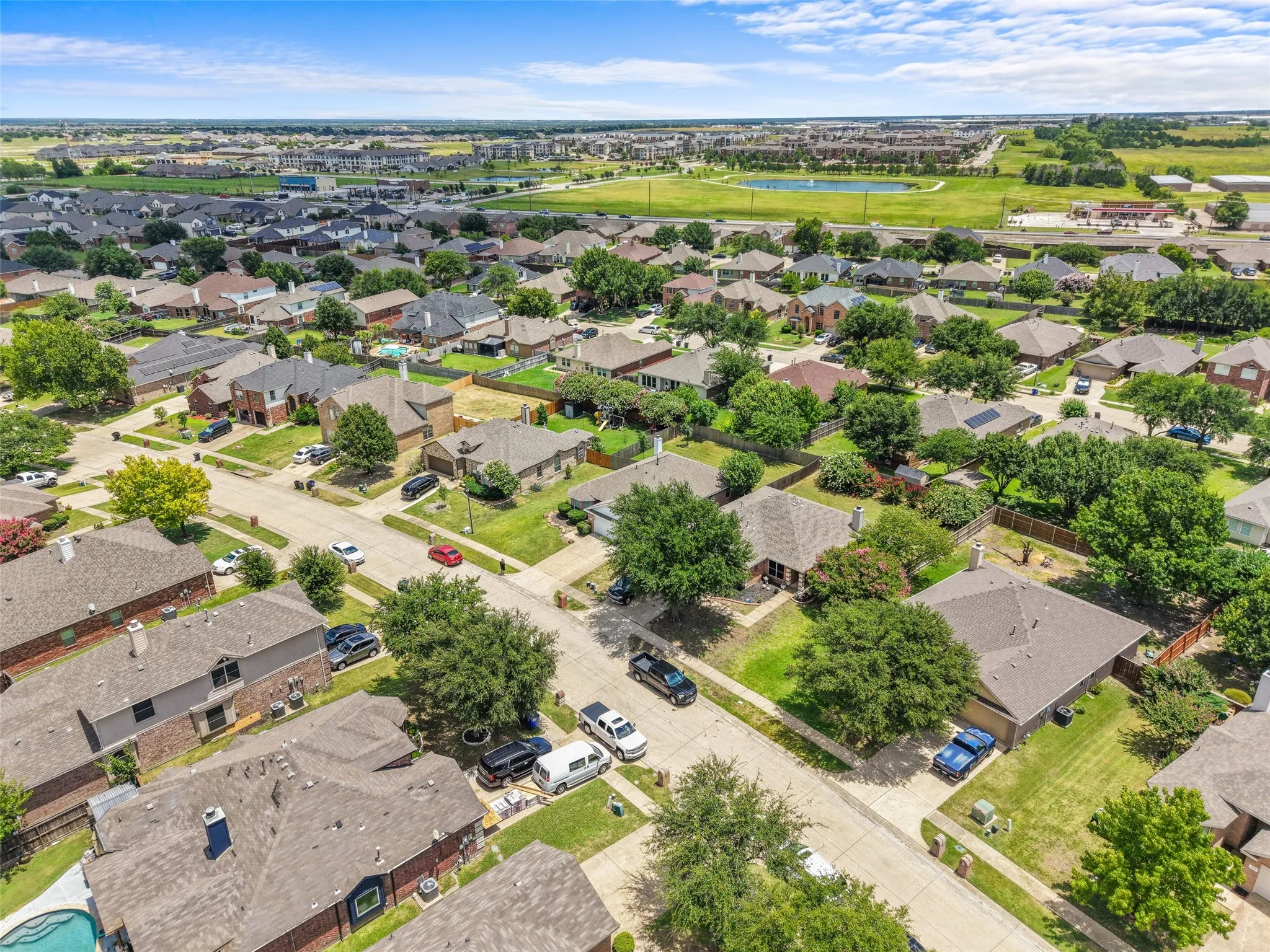 Expansive residential community featuring mature trees, a variety of architectural styles, and well-maintained lawns