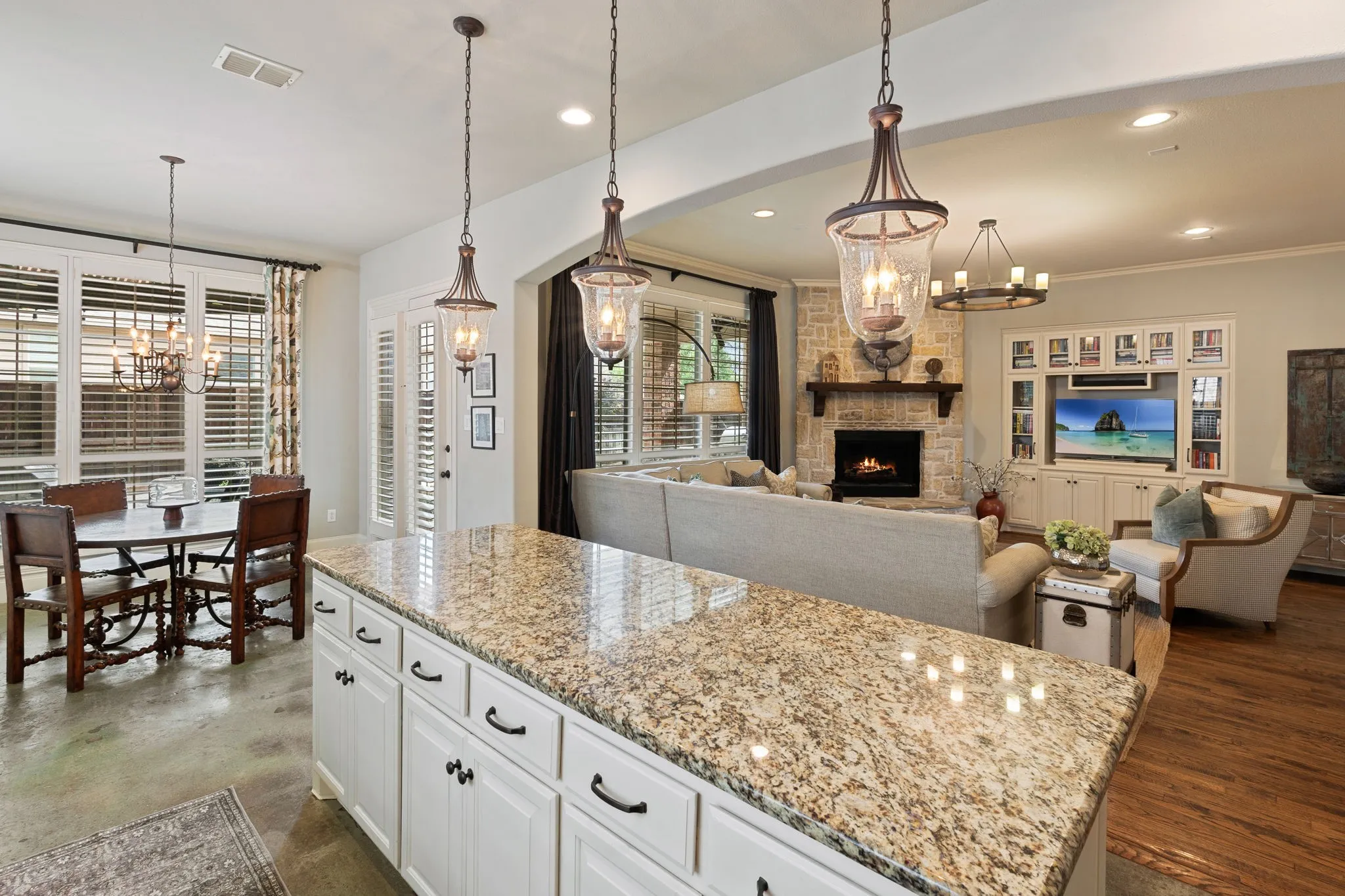Kitchen island with granite countertop and pendant lighting