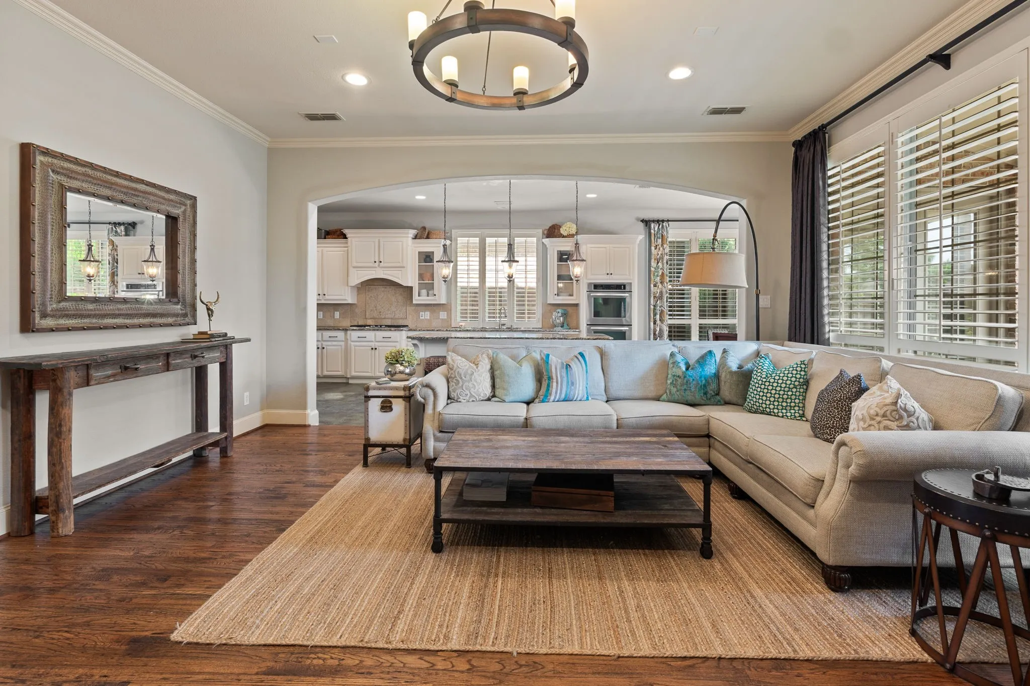Spacious interior featuring rich wood-finish flooring and an arched doorway