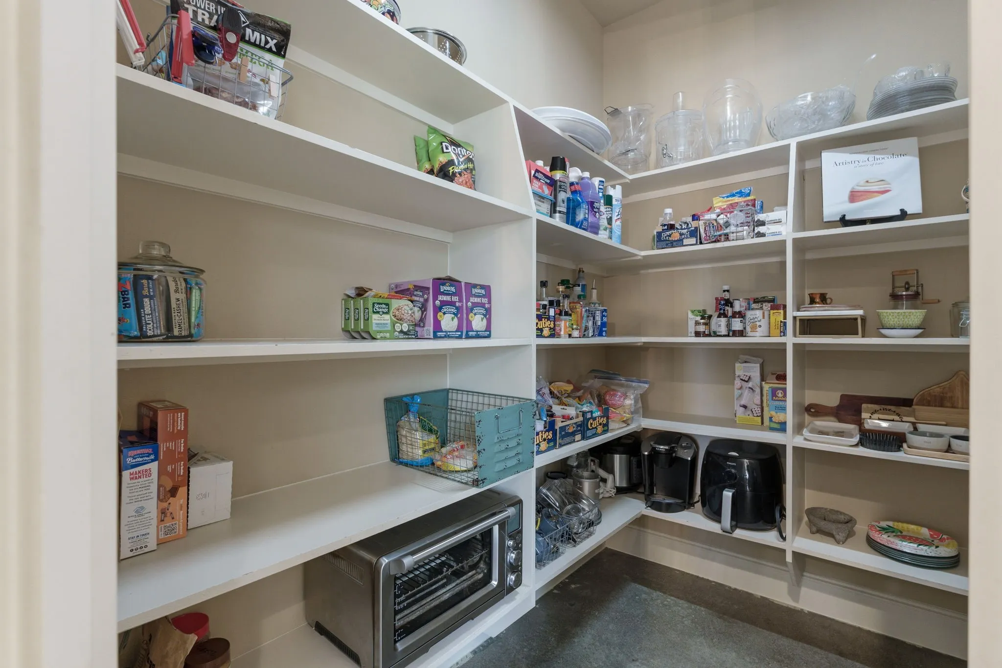 Walk-in pantry with extensive built-in shelving, providing ample storage capacity