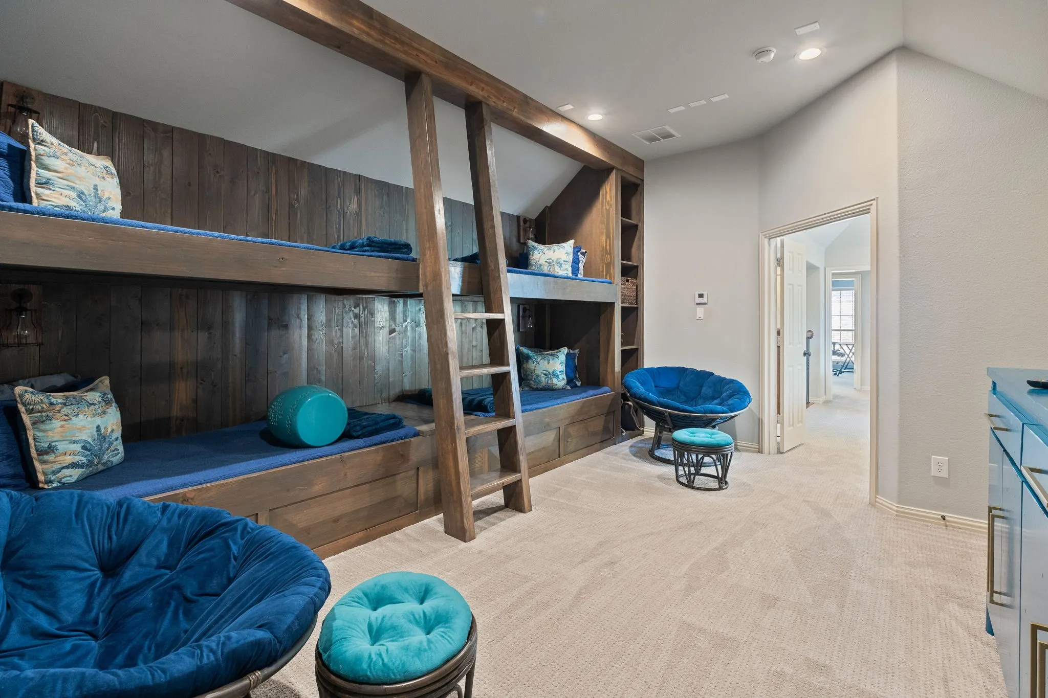 Custom built-in bunk beds with wood-finish paneling and integrated shelving