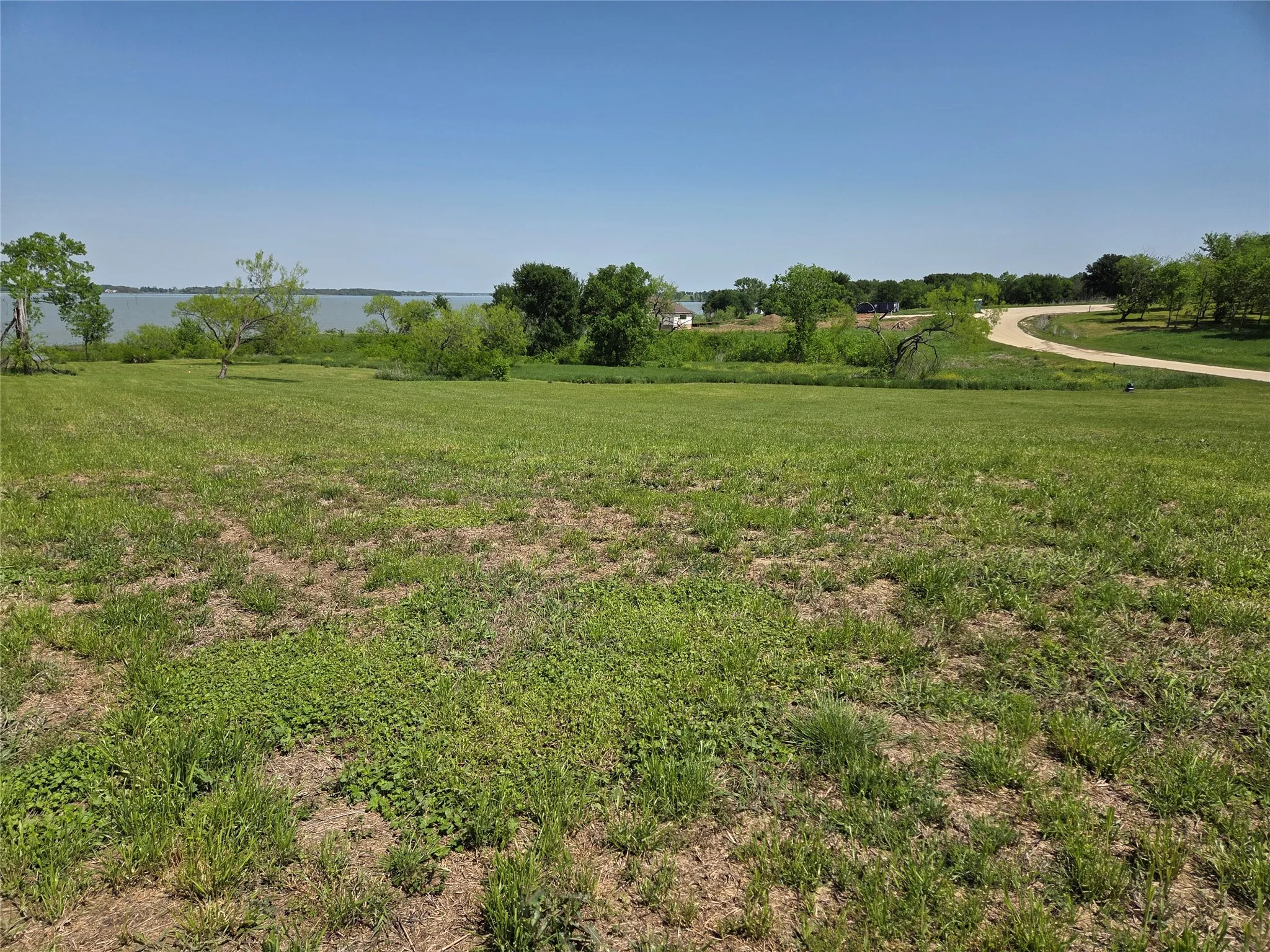 A peaceful first impression of this 2.45-acre homesite, where mature shade trees and open green space create an inviting setting near Richland Chambers Lake.