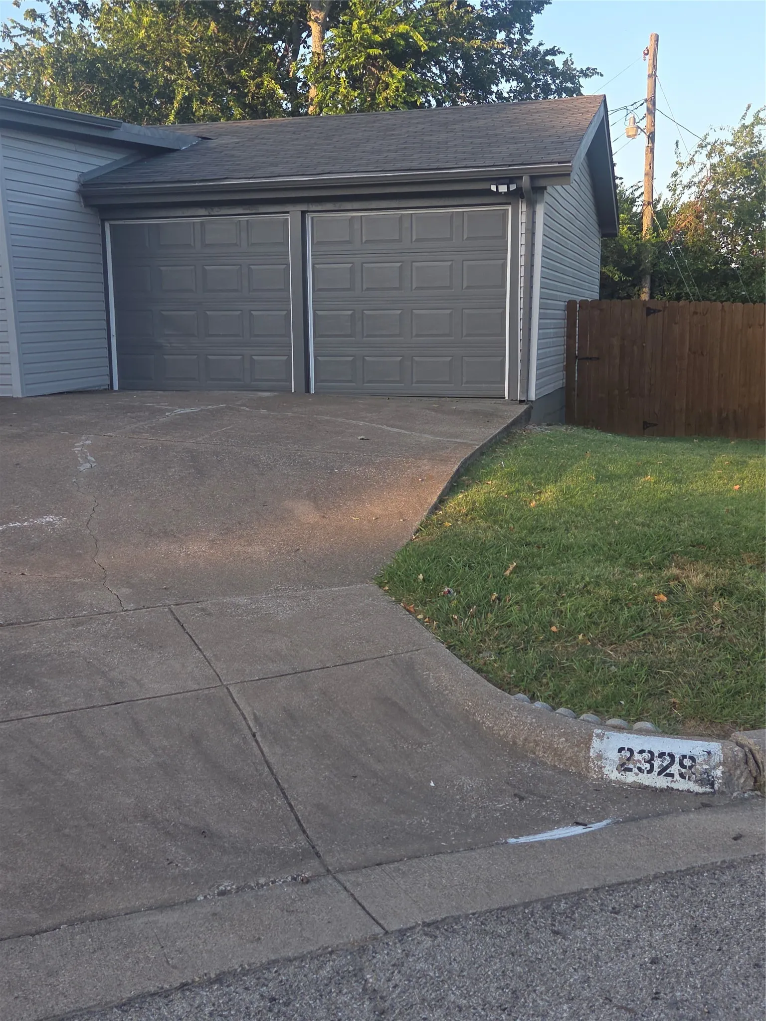 Two-car garage featuring paneled doors and a gabled roofline