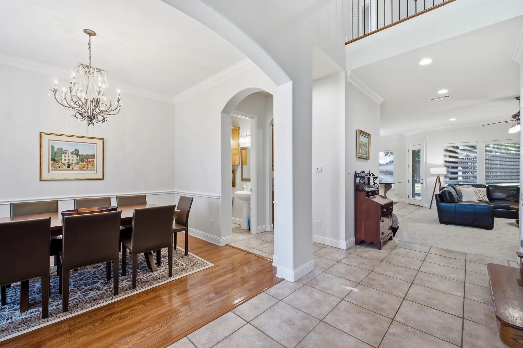 Formal dining area featuring a chandelier, crown molding, and wood-finish flooring