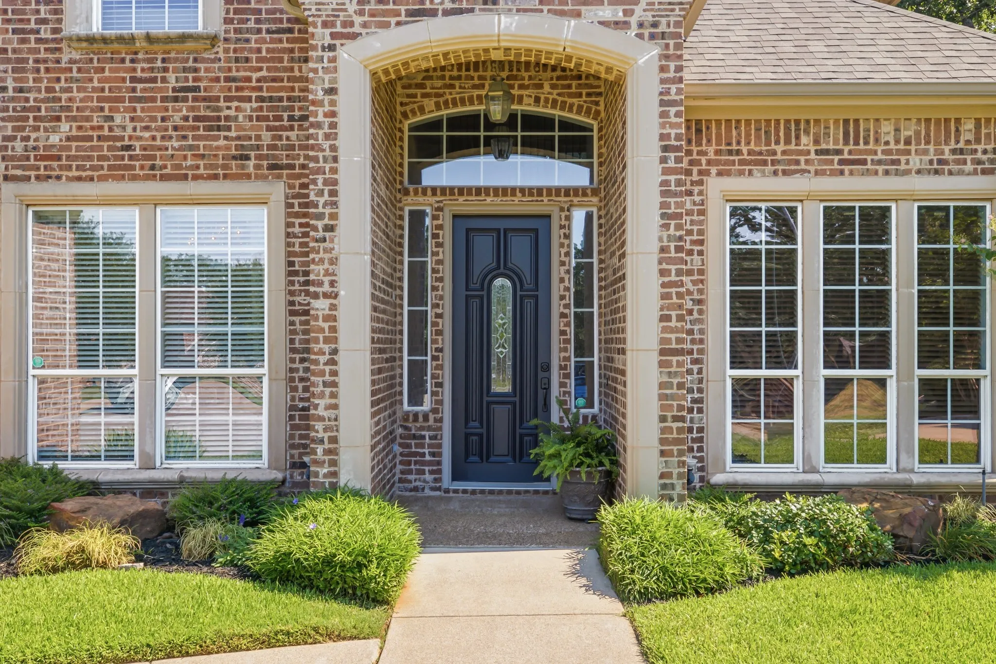Brick exterior with stone accents,featuring an arched entryway