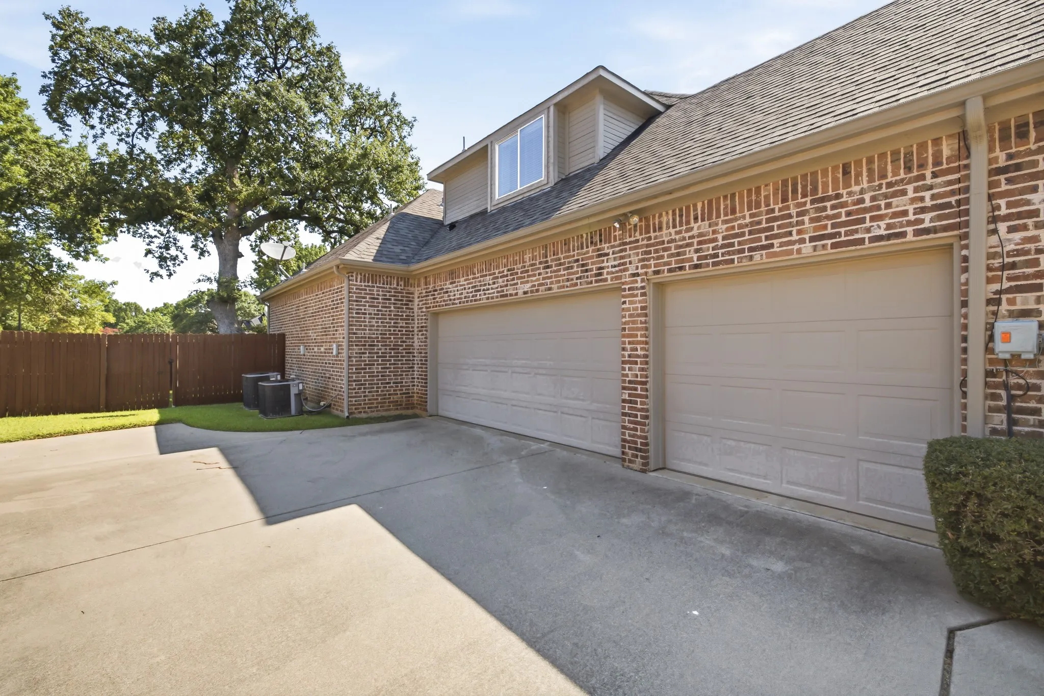 Brick exterior featuring THREE garage
