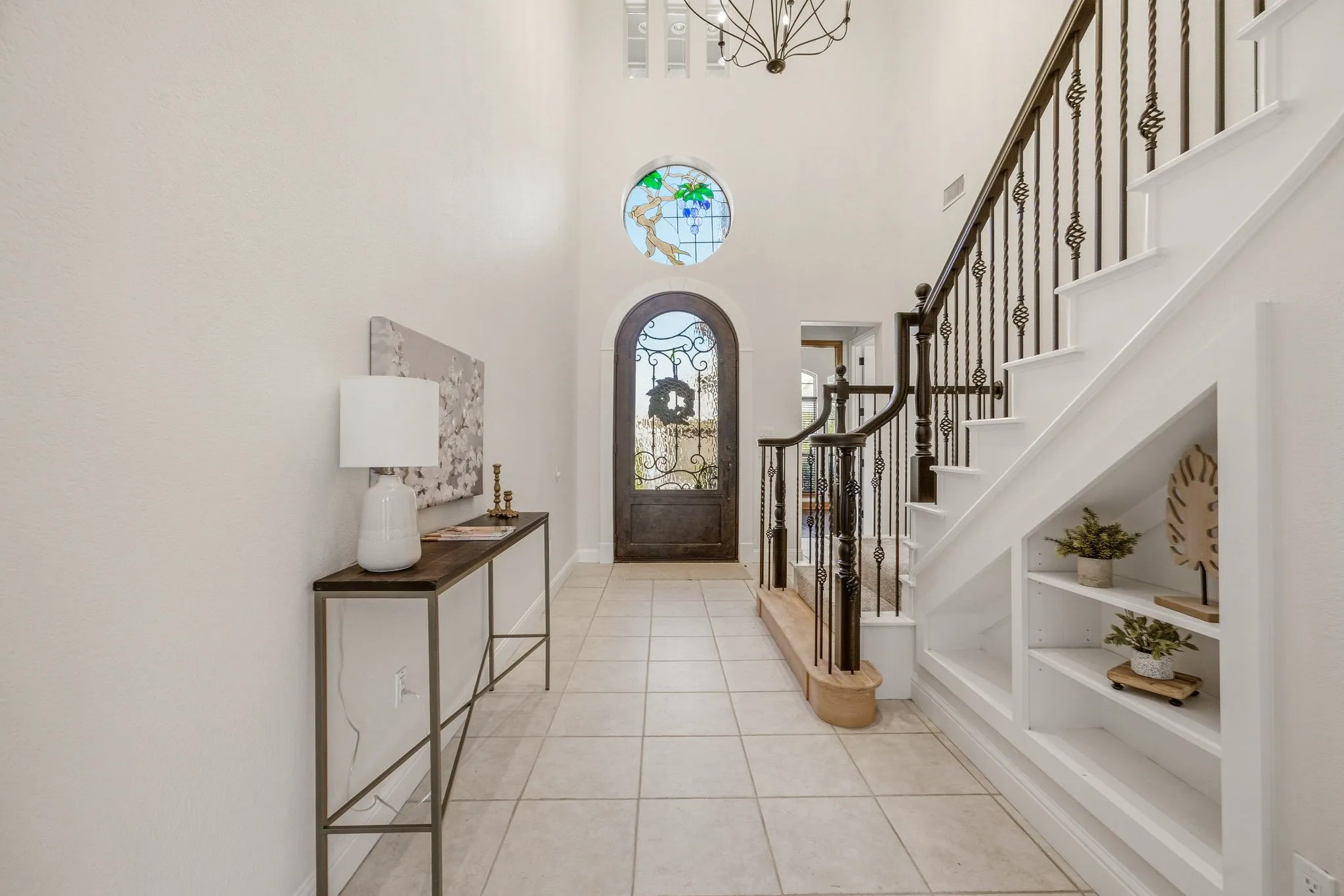 Grand entry featuring a two-story ceiling and tile flooring