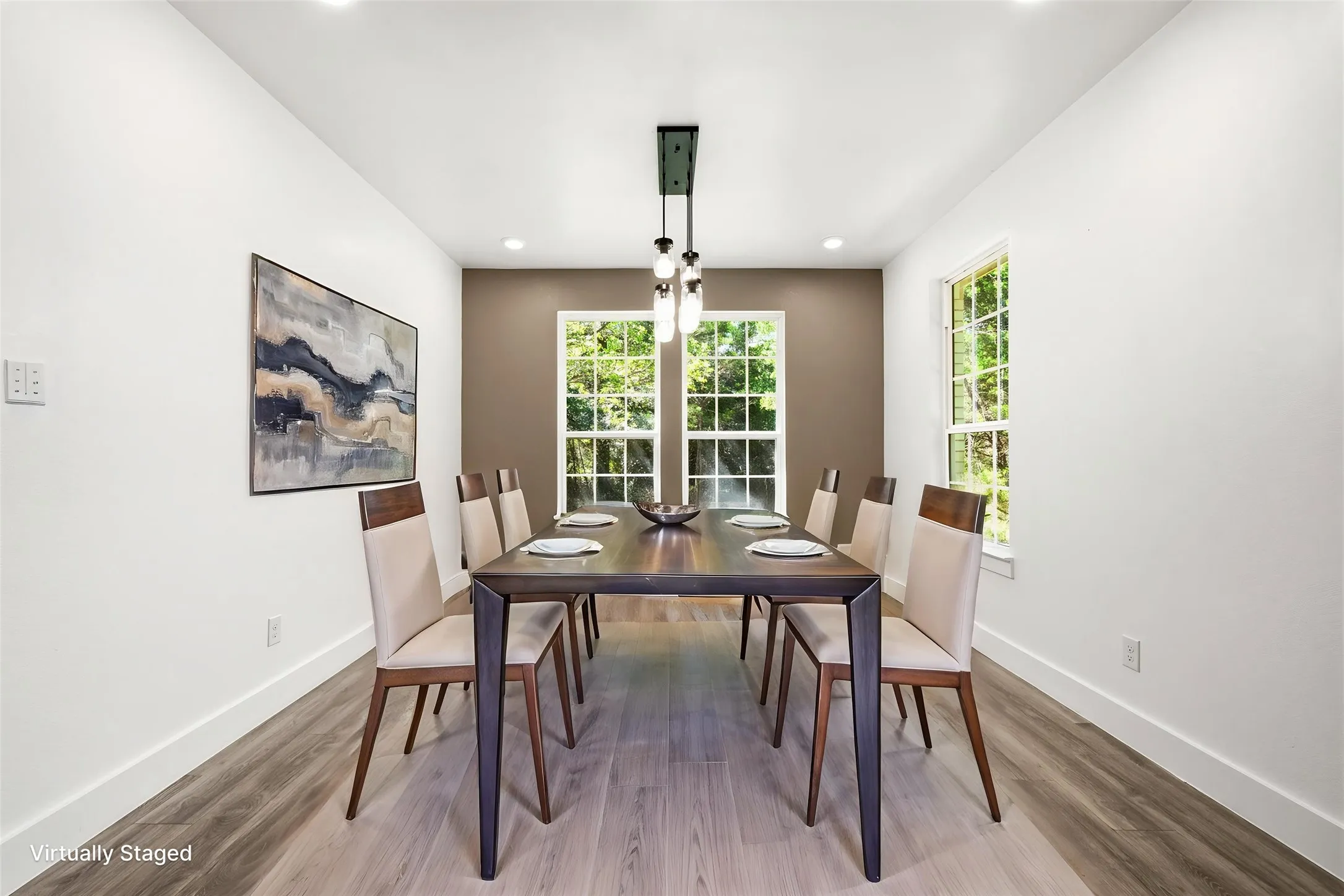 Dining area featuring a contemporary linear pendant light fixture, wood-finish flooring, recessed lighting, and dual pane windows