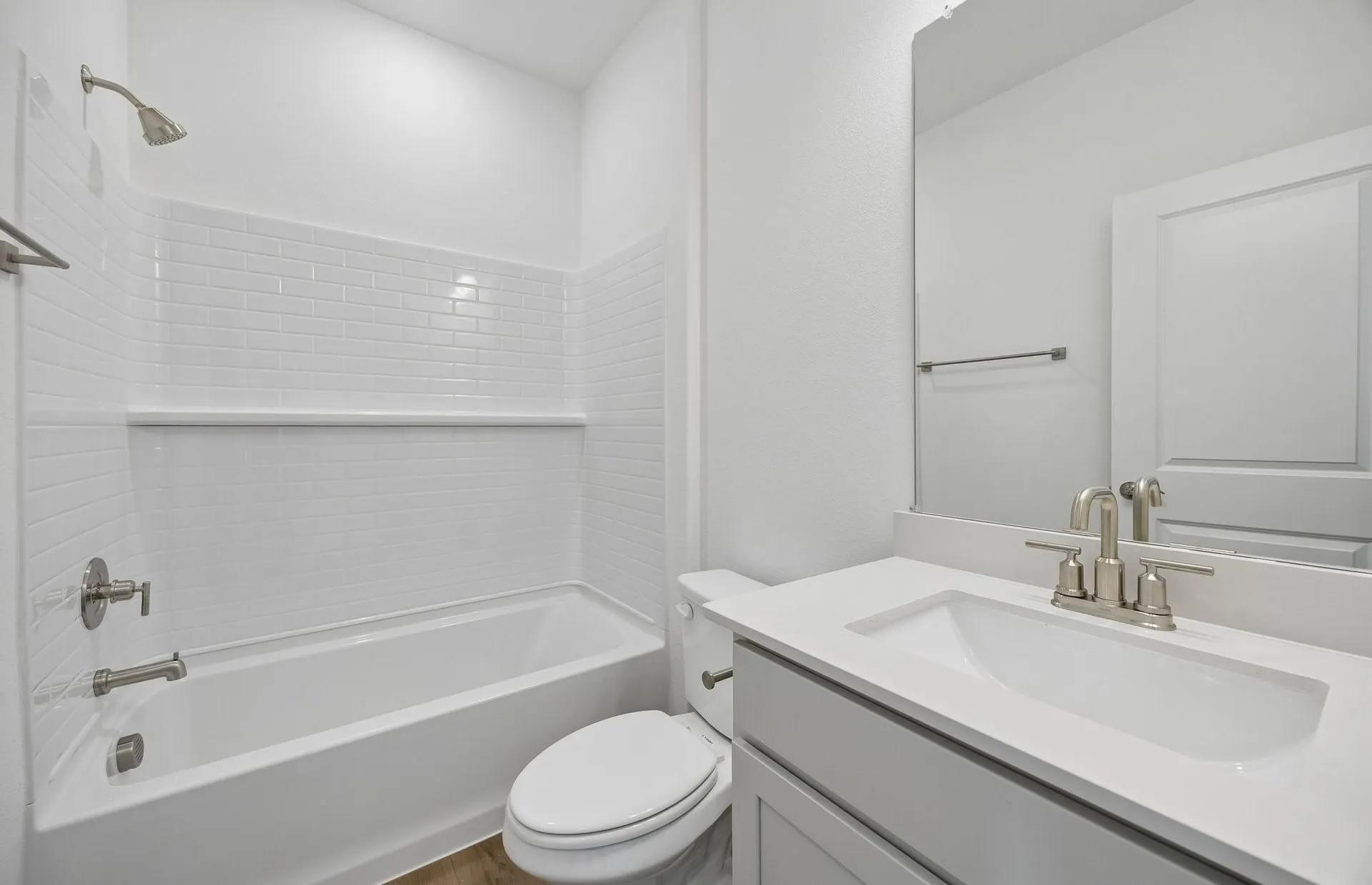 Secondary bedroom with tile surrounded shower