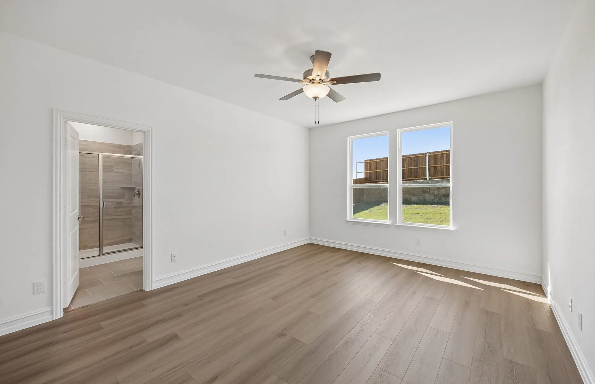 Primary bedroom with large window
