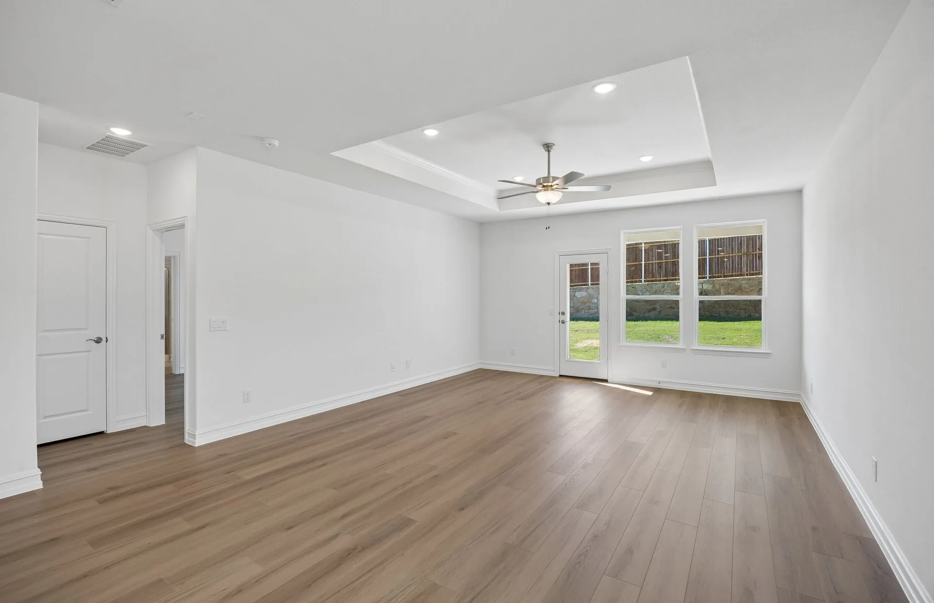 Spacious gathering room with tray ceiling