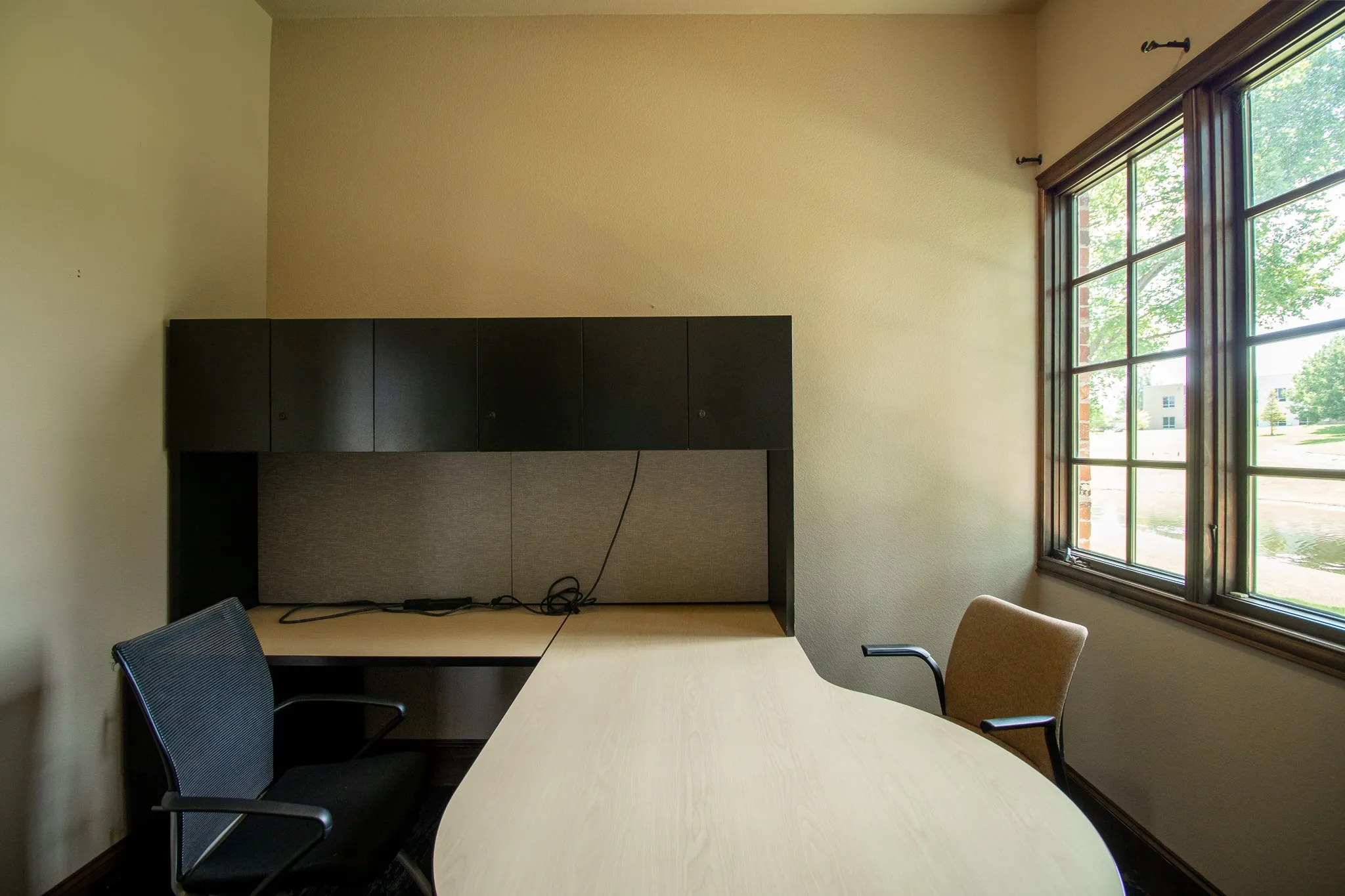 #2 Built-in desk area featuring an integrated hutch with dark cabinetry and a light-toned countertop