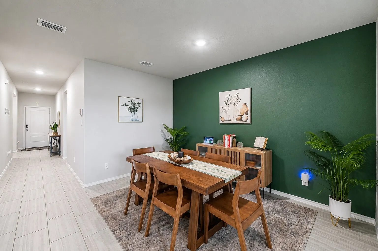 Open-concept dining area featuring a distinct accent wall and recessed lighting