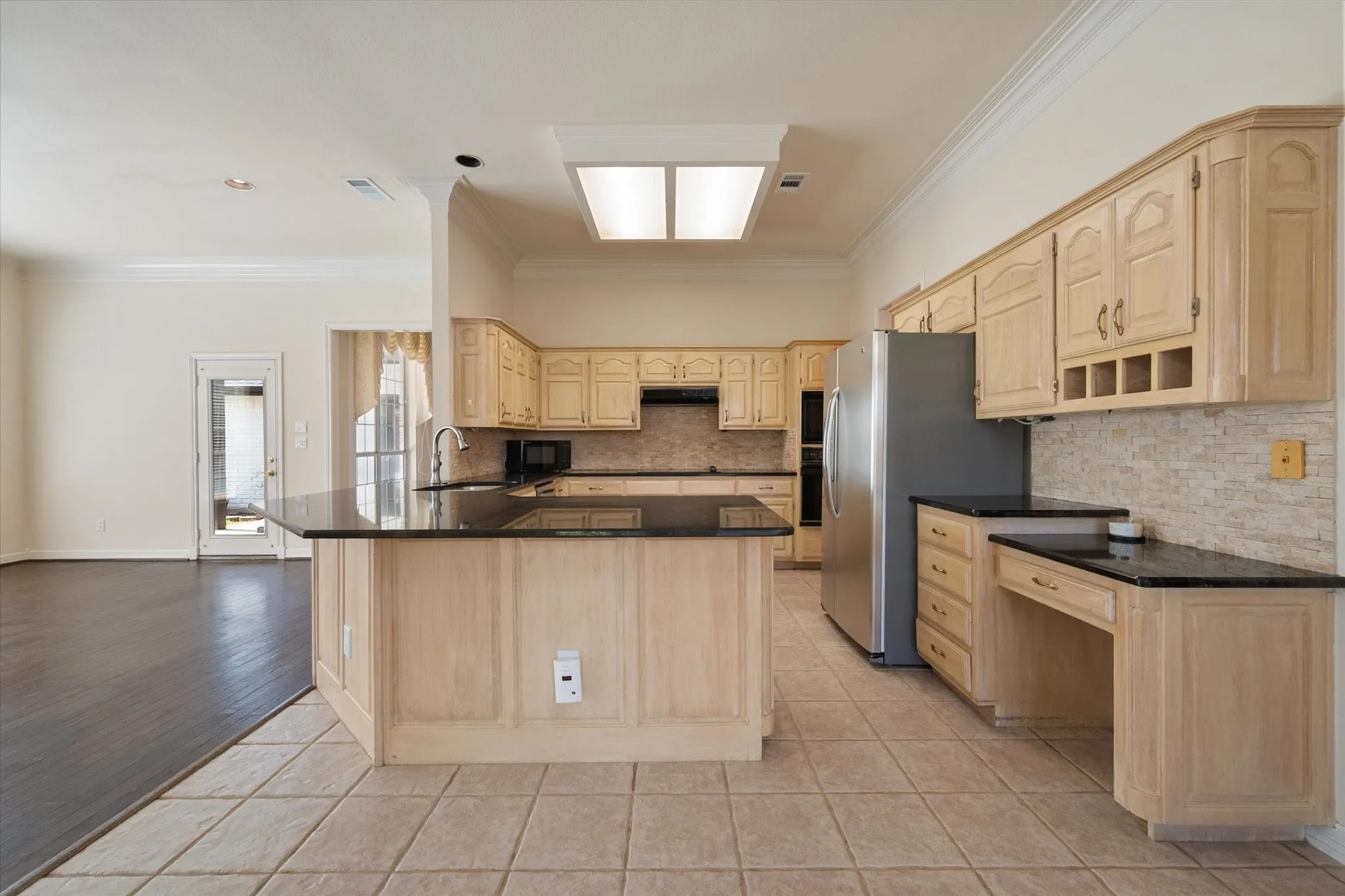 Spacious kitchen with granite counters and abundant custom cabinetry