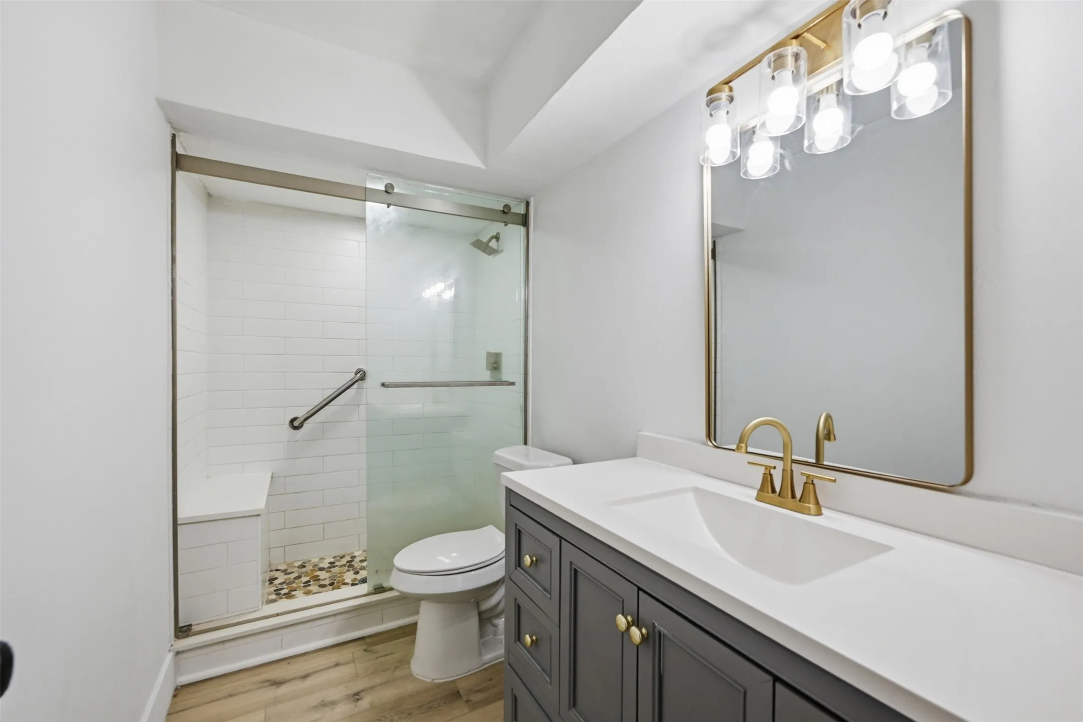 Bathroom featuring a dark gray vanity with a white countertop and a rectangular undermount sink