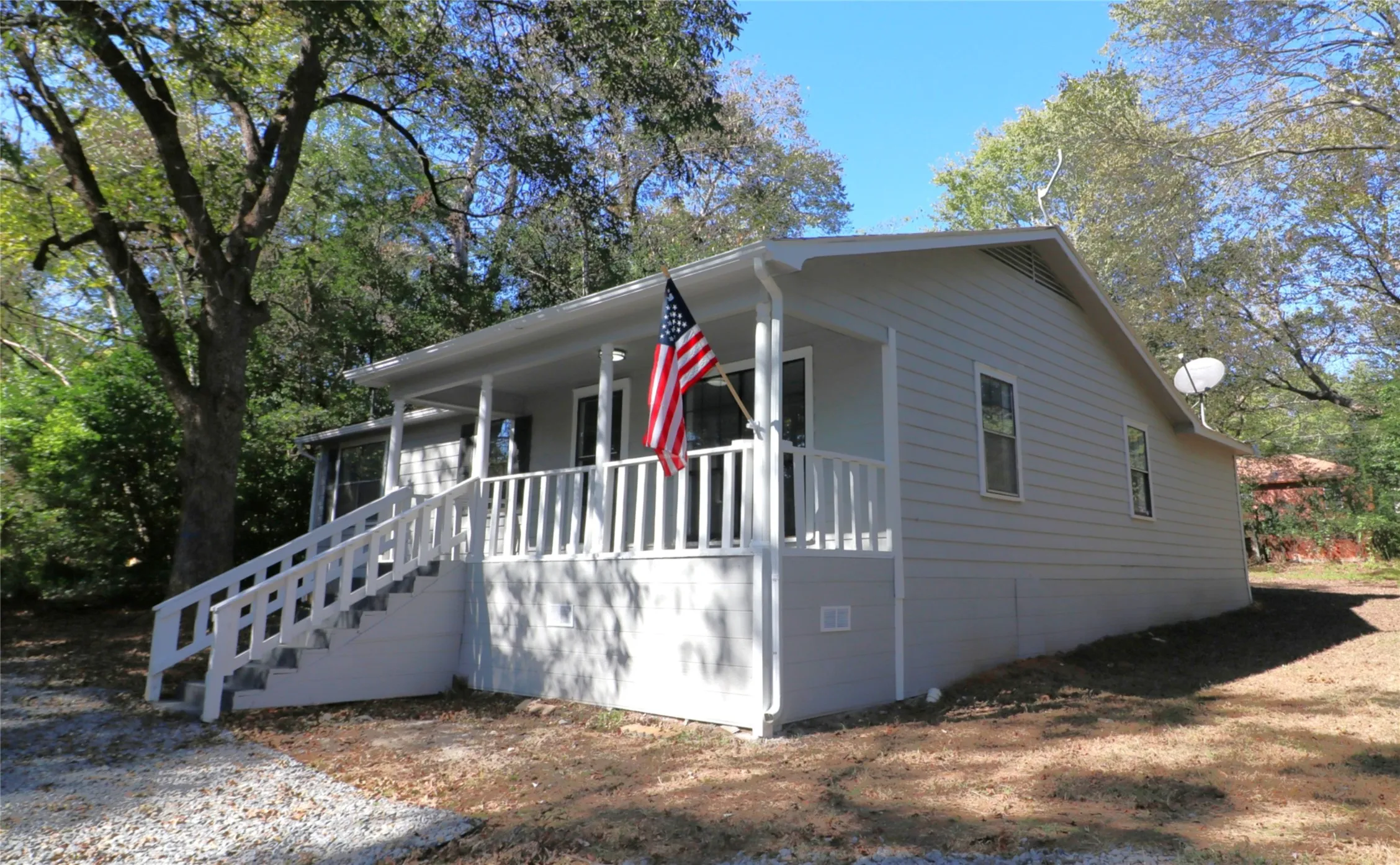 View of front of home featuring covered porch and stairway