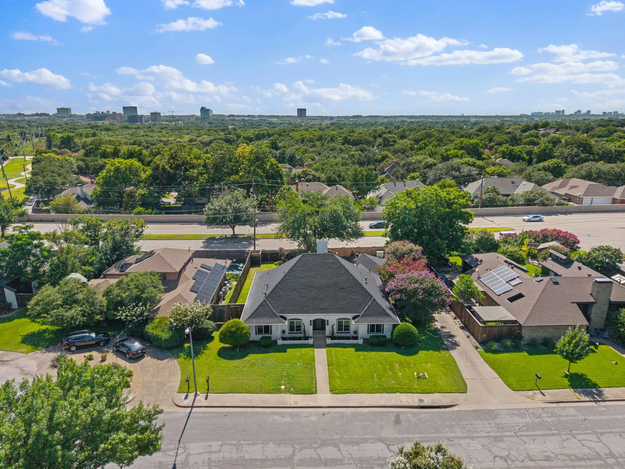 Single-story residence featuring a dark shingled roof and symmetrical front facade