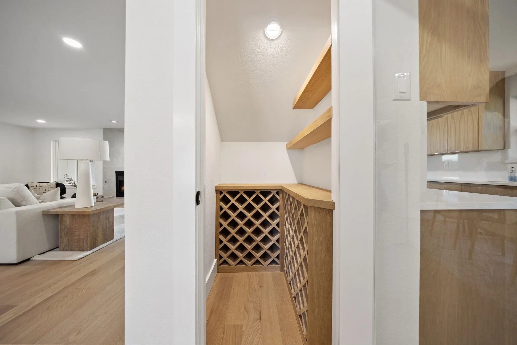 Dedicated storage nook featuring built-in wood wine racks and floating shelves