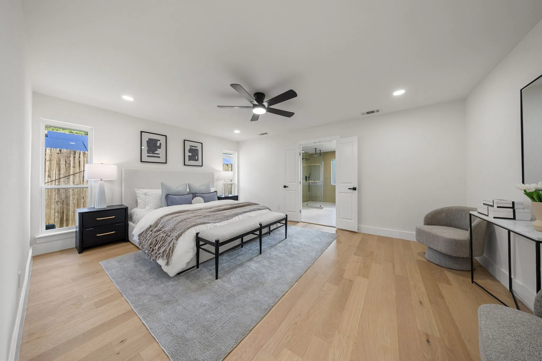 Spacious room featuring light wood-finish flooring, recessed lighting, and a ceiling fan