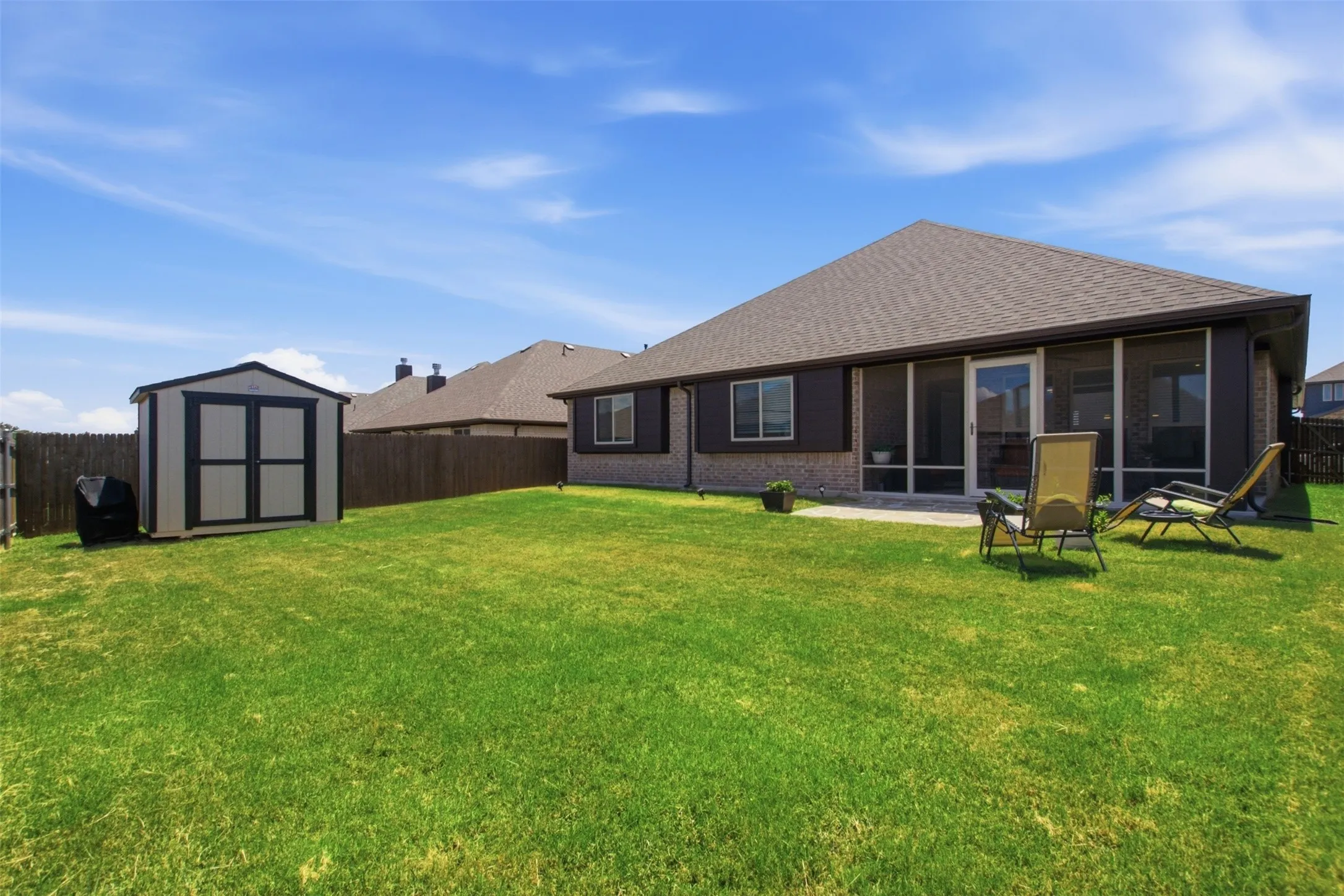 Outdoor storage shed included with the home, offering convenient storage for yard supplies, tools, and lawn equipment.